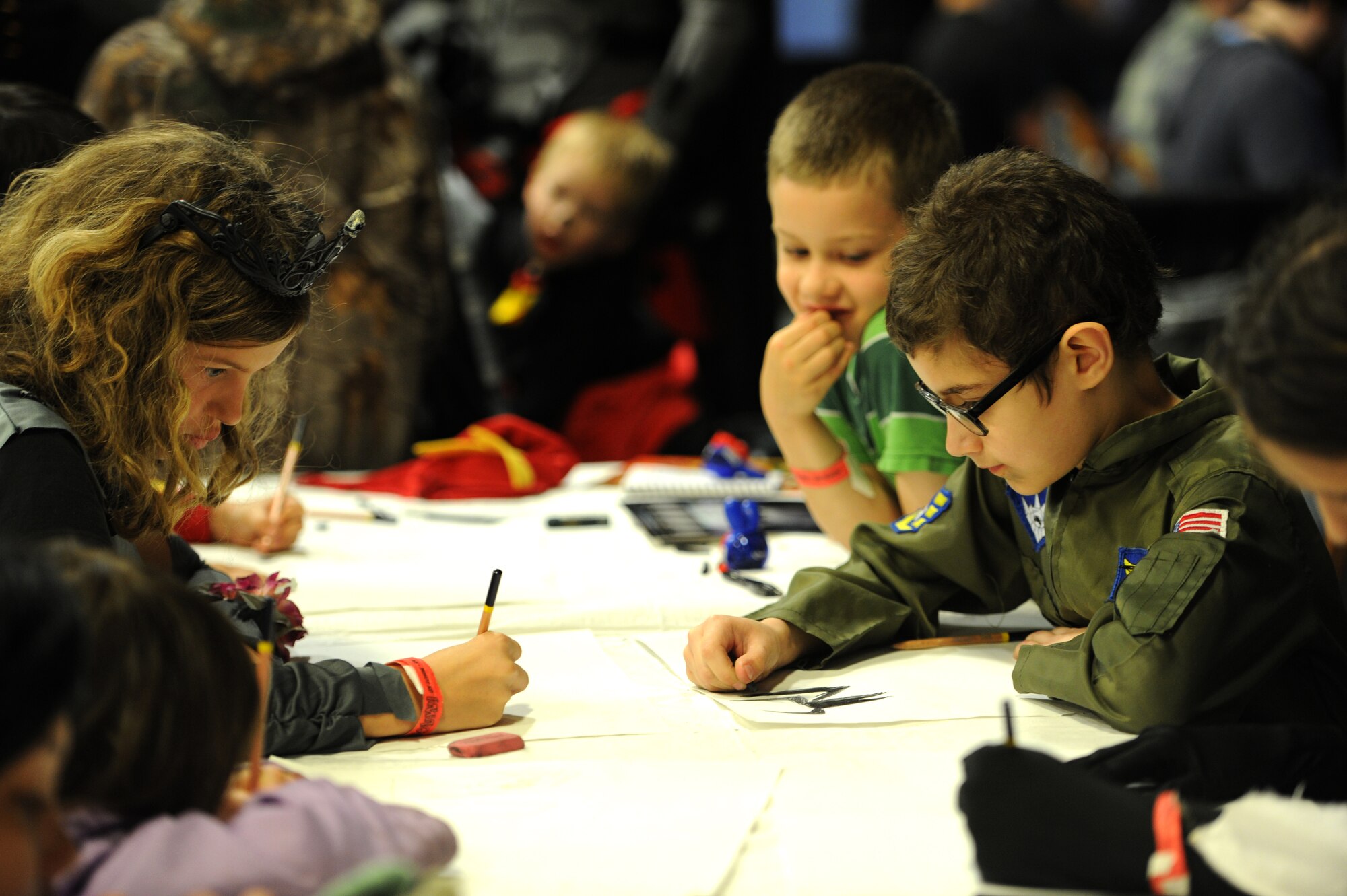 Several children whose parents are Air Force members compete in an art contest  at iMagicon at Minot, N.D. Apr. 23, 2016. iMagicon is a comic book convention that showcases local filmmakers, local businesses and promotes anything pop culture, several Airmen from Minot Air Force Base volunteered during the 3 day event. (U.S. Air Force photo by Staff Sgt. Chad Trujillo)

