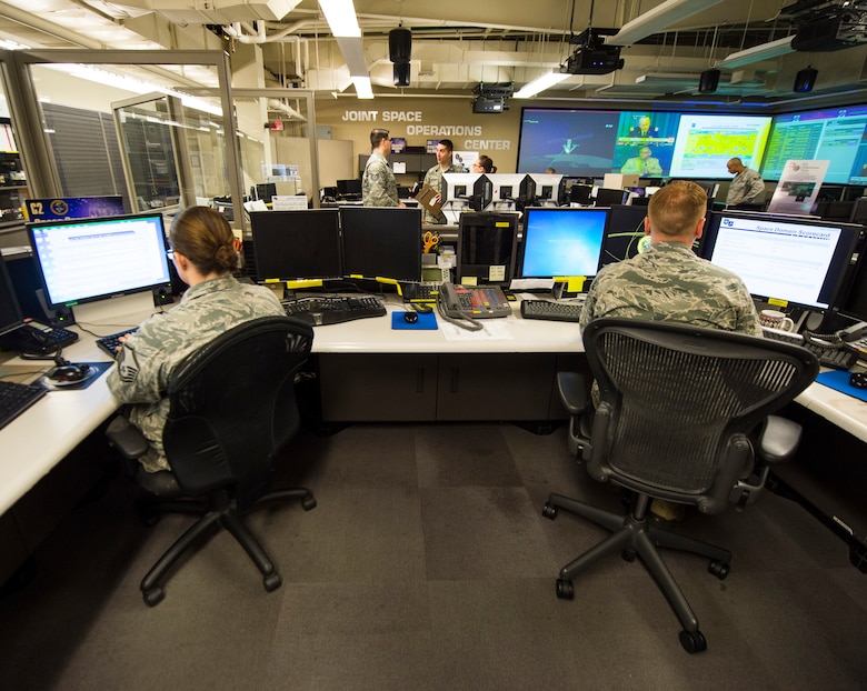 Airmen of the Joint Space Operations Center (JSpOC) monitor computer systems designed to detect, track, and identify all artificial objects in Earth's orbit at Vandenberg AFB, Calif, Sept. 27, 2014. Its mission is to provide a focal point for the operational employment of worldwide joint space forces and enable the commander of Joint Functional Component Command for Space to integrate space power into global military operations. (U.S. Air Force photo by Airman 1st Class Krystal Ardrey)