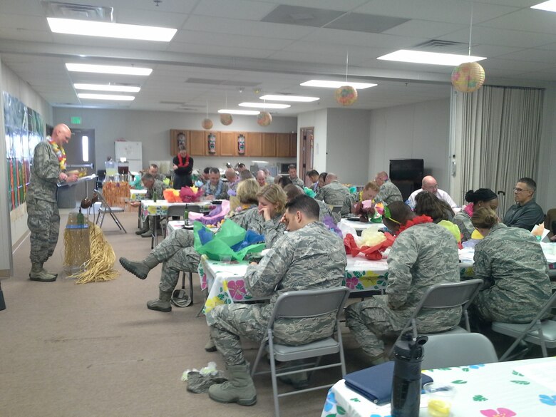 Chaplain (Maj.) Martin Adamson, 50th Space Wing, leads base leadership in a trivia game during a leadership appreciation luncheon at Schriever Air Force Base, Colorado, Tuesday, April 26, 2016. The free luau-themed luncheon was held to honor leaders. It also included games and giveaways. (Courtesy photo)