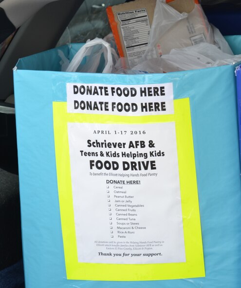 A food collection box sits in the trunk of a vehicle outside the Ellicott Helping Hands Food Pantry in Ellicott, Colorado, Tuesday, April 26, 2016. The box was one of several filled by the Schriever Air Force Base Teens/Kids Helping Kids program during its spring food drive. The flyer on the front of the box was given to patrons of the Peterson Air Force Base commissary during a collection event April 23-24. (U.S. Air Force photo/Brian Hagberg)
