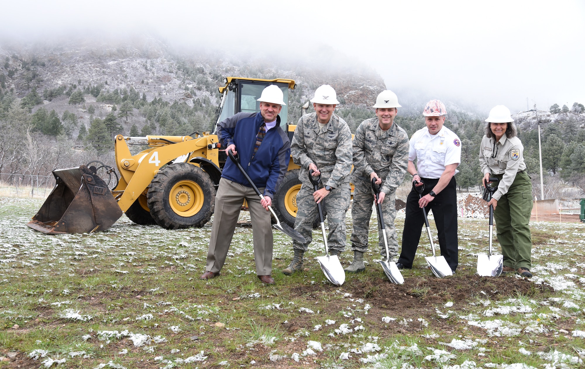 CHEYENNE MOUNTAIN AIR FORCE STATION, Colo. – Col. Doug Schiess, 21st Space Wing commander (center), Cheyenne Mountain Air Force Station leadership and an Air Force Wildland Fire Center representative break ground at CMAFS Fire Department Fire Station 2 April 28. The $1.8 million renovation will ensure the steadfastness of equipment and personnel to meet the ever-growing mission needs. (U.S. Air Force photo/Airman 1st Class Dennis Hoffman)