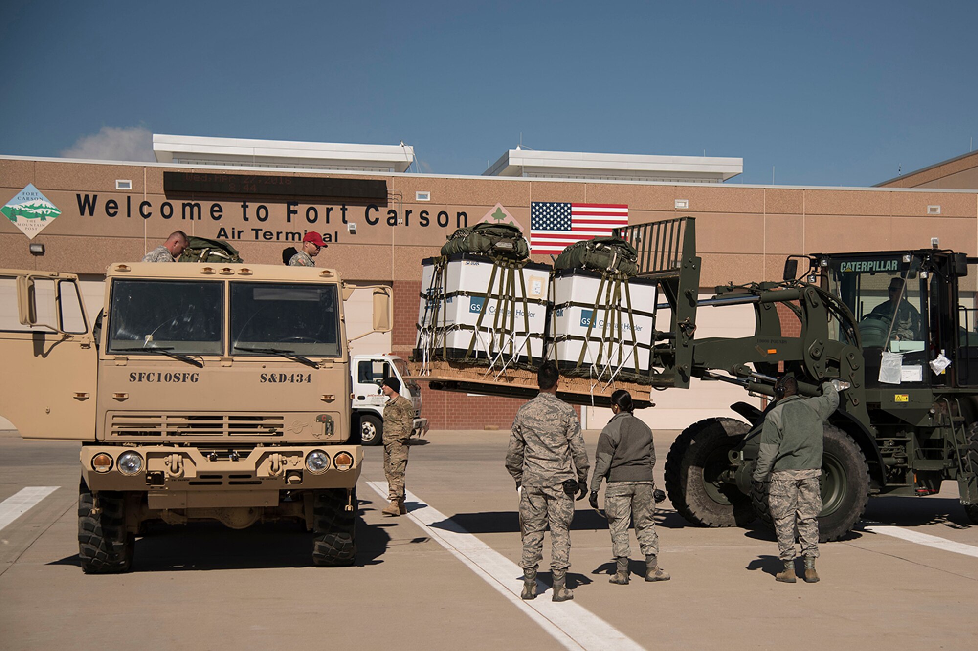 COLORADO SPRINGS, Colo. - Airmen from 821st Contingency Response Group, Travis Air Force Base, Calif., prepare equipment to load onto supporting C-130s during a fire response exercise at the Arrival/Departure Airlift Control Group in Colorado Springs, April 27, 2016. The 21st Logistics Readiness Squadron provides support, equipment and space to missions from all over the country. (U.S. Air Force photo/Staff Sgt. Tiffany DeNault)