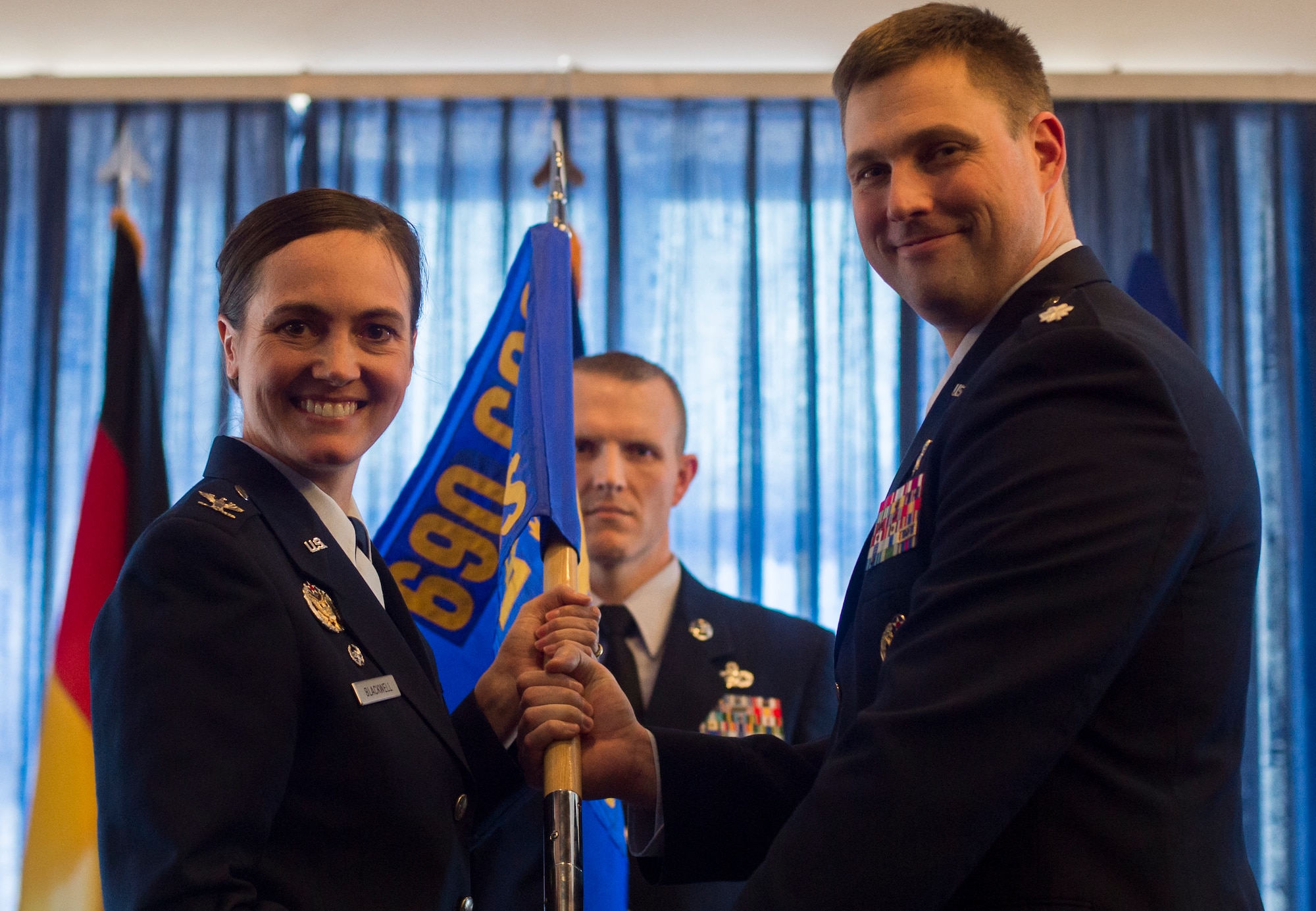 Col. Heather Blackwell, 690th Cyberspace Operations Group commander, passes the guideon to Lt. Col. Michael Medgyessy during the 691st Cyberspace Operations Squadron activation ceremony April 21, 2016, at Ramstein Air Base, Germany. Due to the cyberspace environment constantly evolving, the 691st COS team has the intent to strengthen the new unit by maturing its capabilities and grow the Cyber Security and Control weapon system and the operational capabilities of the unit. (U.S. Air Force photo/Senior Airman Jonathan Stefanko)