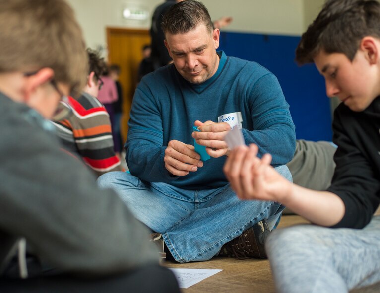 Master Sgt. Michael Peters, U.S. Air Forces in Europe long-haul systems communications manager, creates origami shapes with local national children during a community engagement event held in Landstuhl, Germany, April 23, 2016. More than 10 Airmen from Ramstein Air Base, Germany, participated in the event to build partnerships with the local community and improve rapport through games. (U.S. Air Force photo/Senior Airman Jonathan Stefanko)