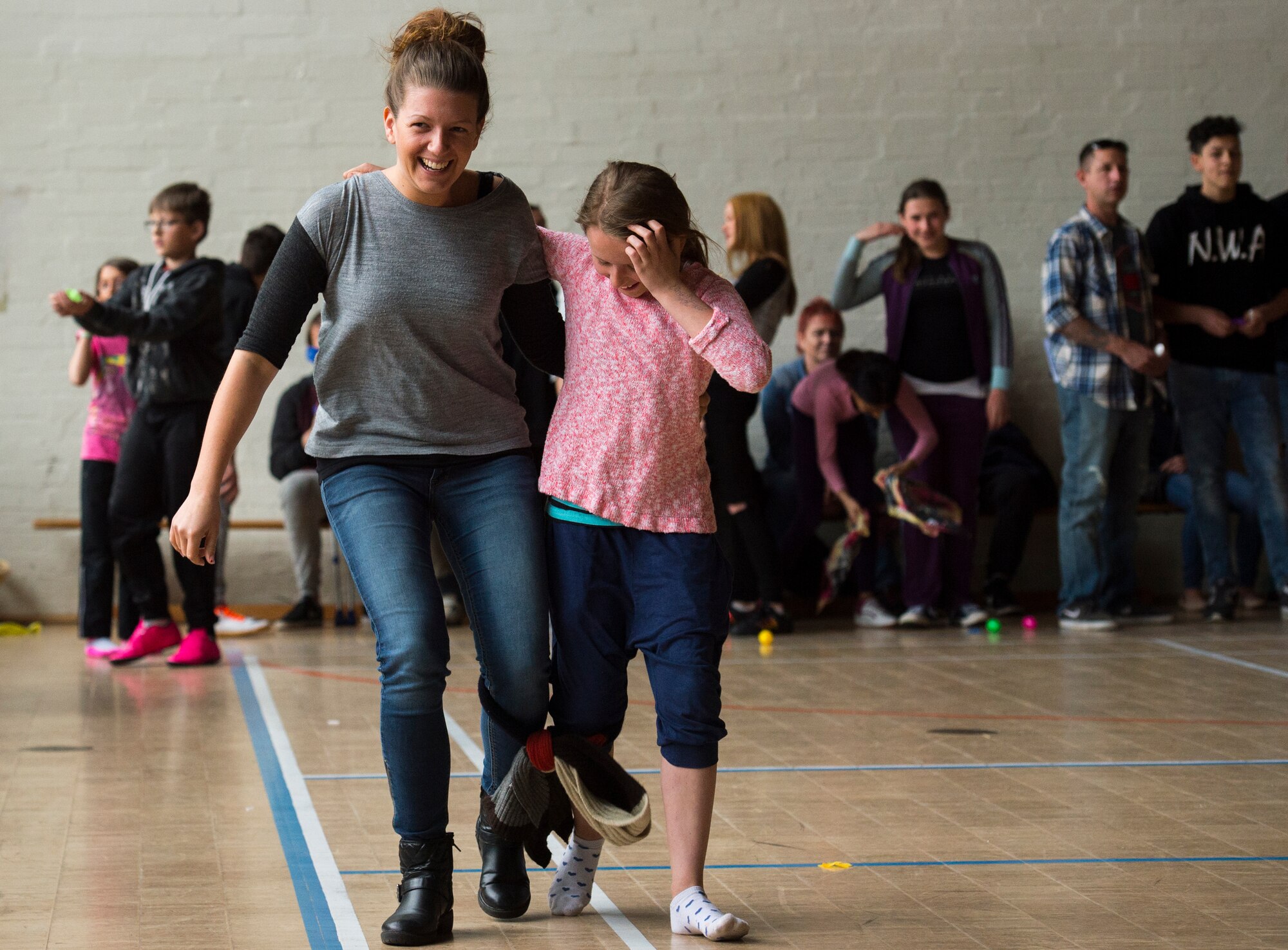 Lisa, left, and AyLeen, right, participate in a three-legged race during a community engagement event led by Airmen from Ramstein Air Base, Germany April 23, 2016, in Landstuhl, Germany. More than 10 Airmen participated in the event to build partnerships with the local community and improve rapport. (U.S. Air Force photo/Senior Airman Jonathan Stefanko)