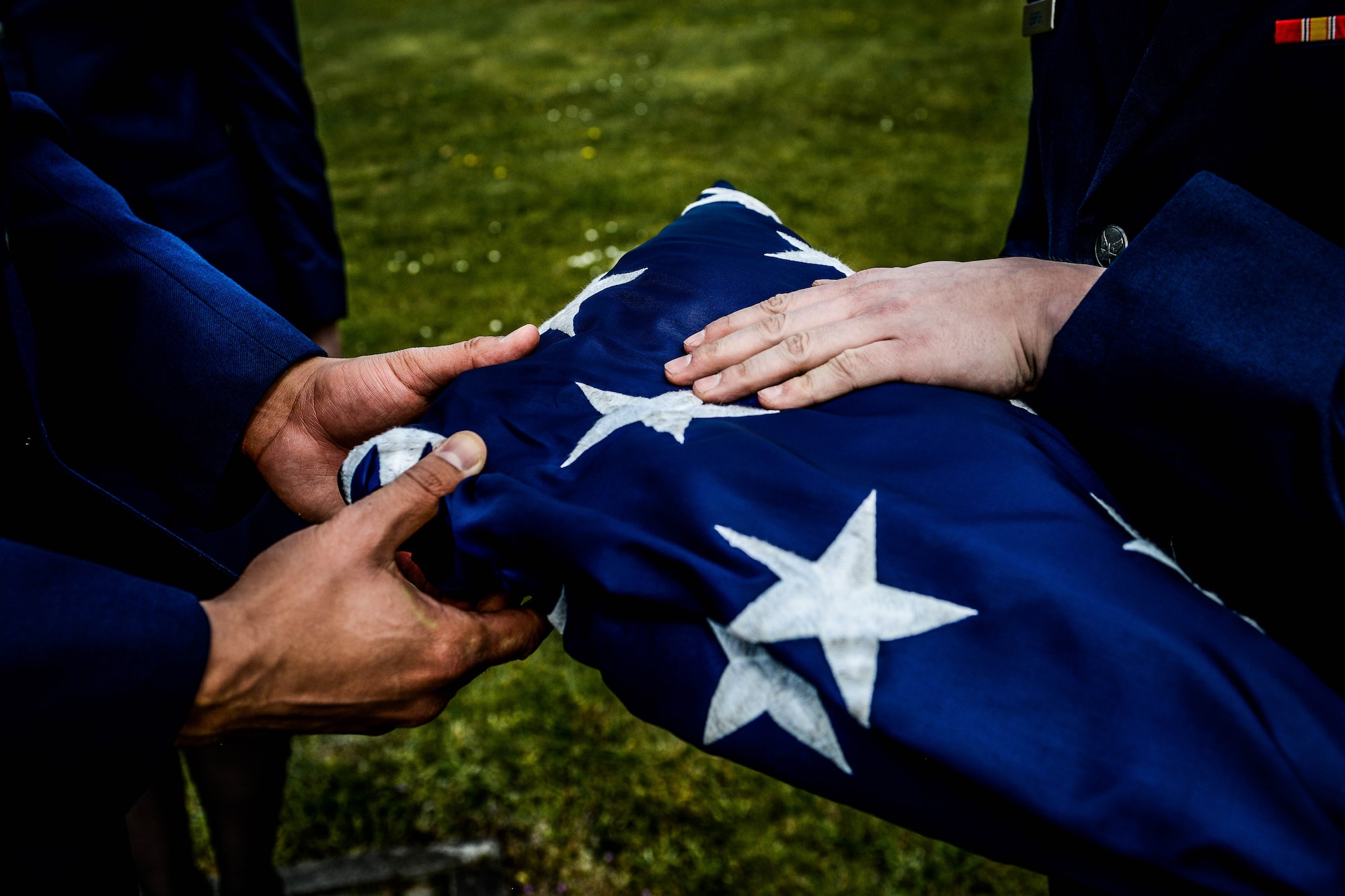 Airmen from the 86th Operations Group hold the U.S. flag during a retreat and remembrance ceremony April 29, 2016, at Ramstein Air Base, Germany.  Airmen from the 86th Operations Group gathered for the ceremony to recognize the Implementation Force 21 crew from the 76th Airlift Squadron who gave the ultimate sacrifice 20 years ago when their aircraft was lost during an approach into Dubrovnik, Croatia. (U.S. Air Force photo/Senior Airman Nicole Keim)