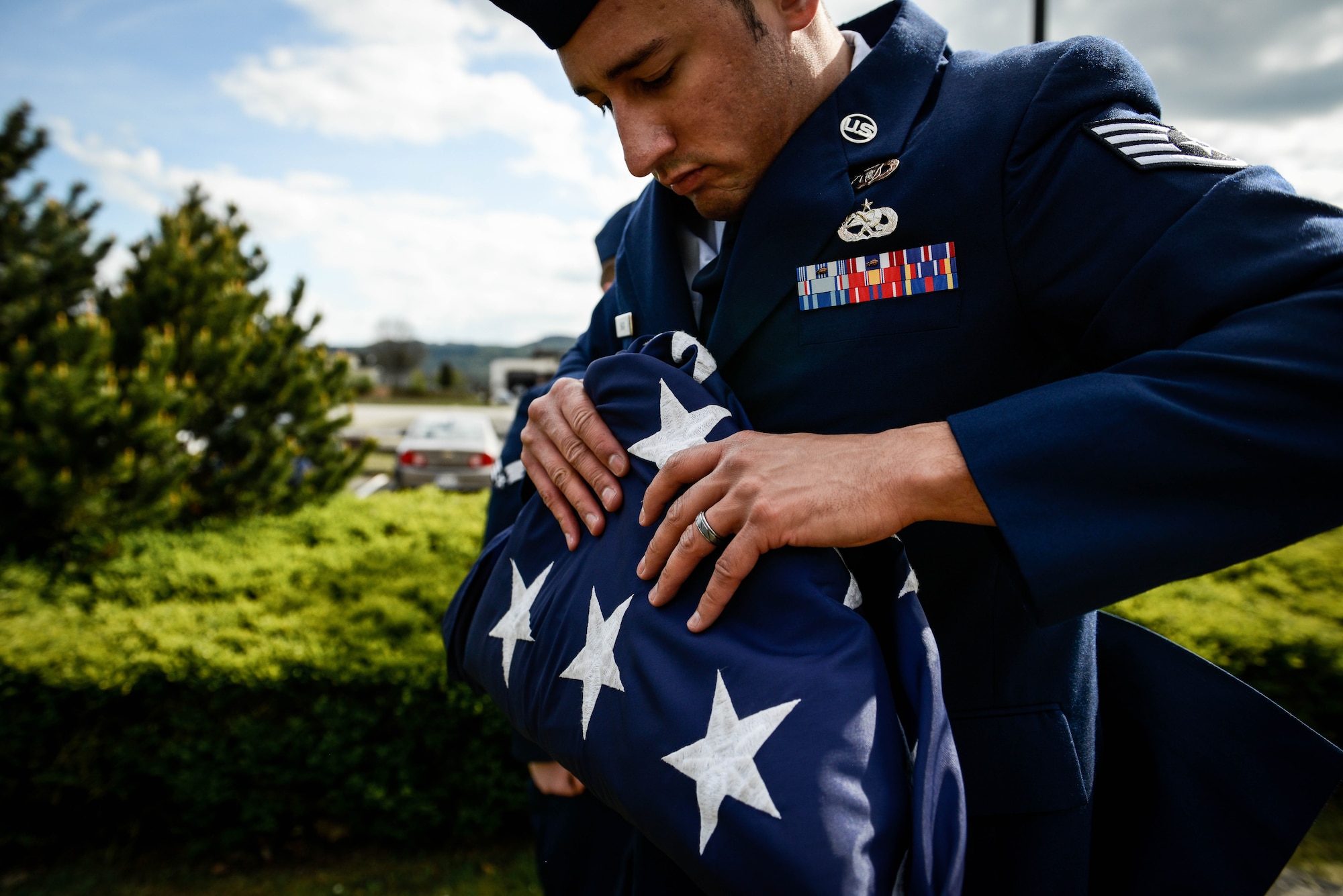 Staff Sgt. Joshua D. Baca, 86th Operations Support Squadron host aviation resource manager, folds the U.S. flag during a retreat and remembrance ceremony April 29, 2016, at Ramstein Air Base, Germany.  Airmen from the 86th Operations Group gathered for the ceremony to recognize the Implementation Force 21 crew from the 76th Airlift Squadron who gave the ultimate sacrifice 20 years ago when their aircraft was lost during an approach into Dubrovnik, Croatia. (U.S. Air Force photo/Senior Airman Nicole Keim)