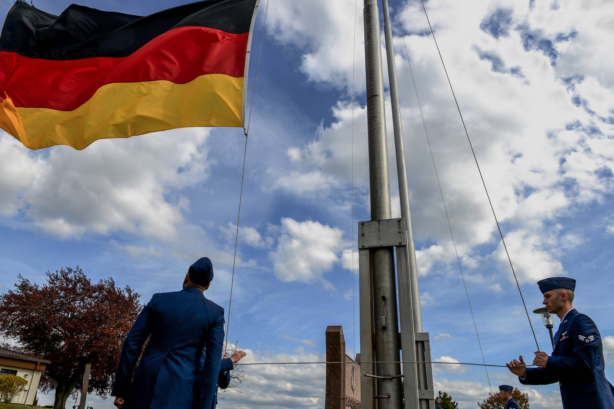 Airmen from the 86th Operations Group lower the German flag during a retreat and remembrance ceremony April 29, 2016, at Ramstein Air Base, Germany.  Airmen from the 86th OG gathered for the ceremony to recognize the Implementation Force 21 crew from the 76th Airlift Squadron who gave the ultimate sacrifice 20 years ago when their aircraft was lost during an approach into Dubrovnik, Croatia. (U.S. Air Force photo/Senior Airman Nicole Keim)