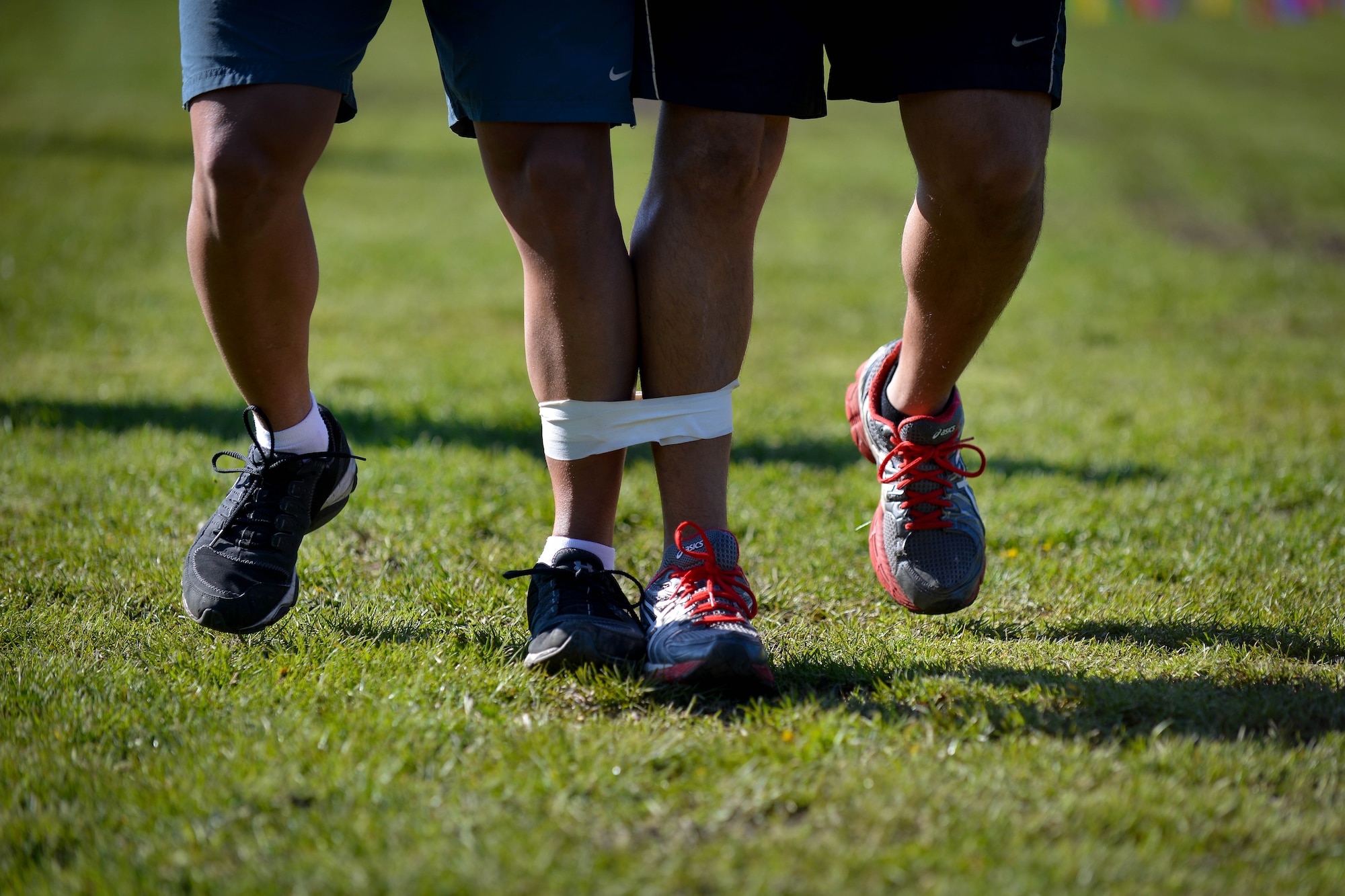Airmen participate in a three-legged race during Courage, Leadership, Education, Advocate and Respect course April, 29, 2016, at Vogelweh Military Complex, Germany. During the obstacle course, Airmen and Soldiers from the Kaiserslautern Military Community got a chance to wear “drunk goggles” to simulate the feeling of functioning under the influence of alcohol. (U.S. Air Force photo/Senior Airman Nicole Keim)