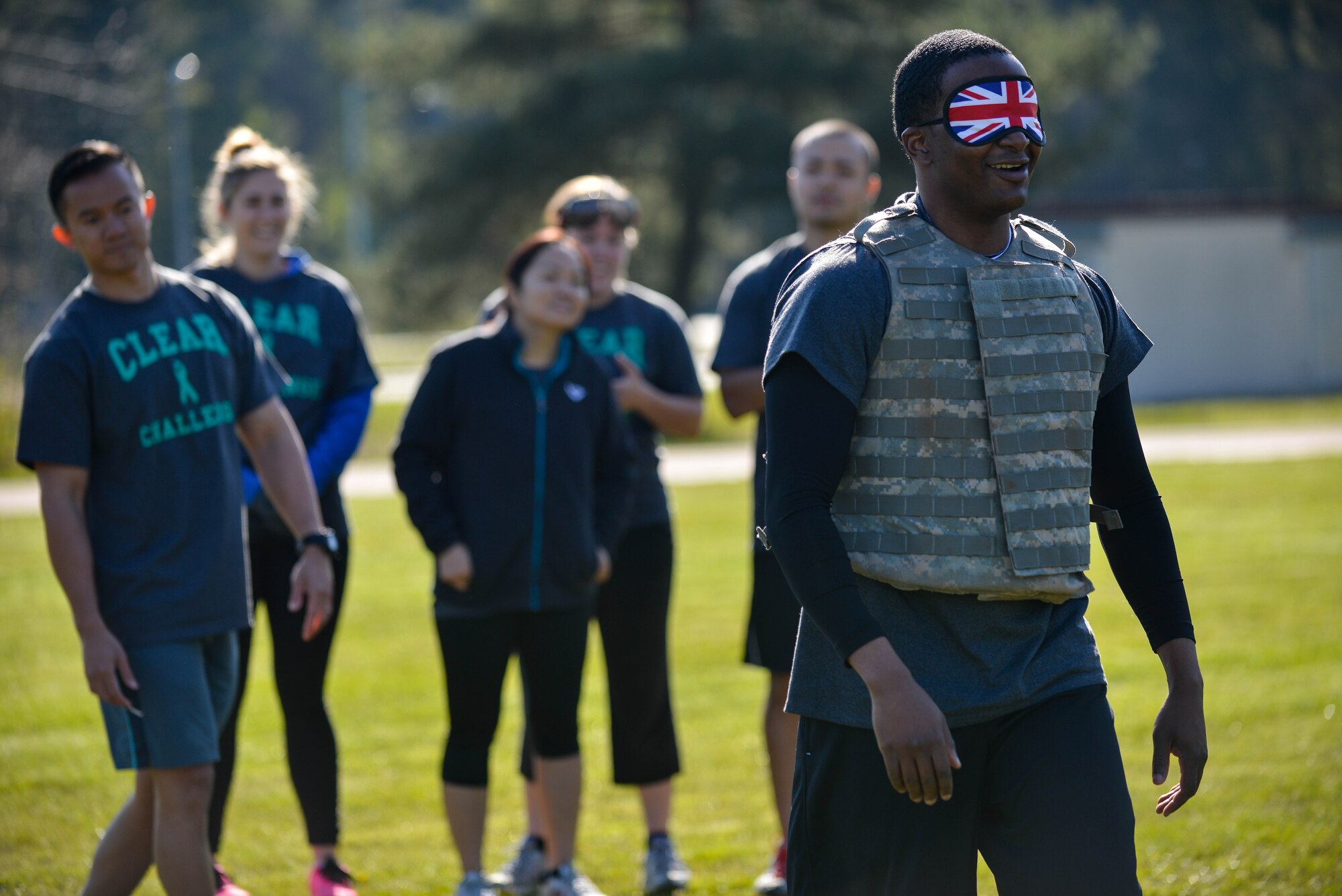 Staff Sgt. Stefan Norton, 3rd Air Force NCO in charge of awards and evaluations, walks blind-folded while his team guides him through an obstacle during the Courage, Leadership, Education, Advocate and Respect course April, 29, 2016, at Vogelweh Military Complex, Germany.  The course was comprised of 10 obstacles that challenged more than 20 teams with situations to simulate the feeling of intoxication and the effects of sexual assault. (U.S. Air Force photo/Senior Airman Nicole Keim)