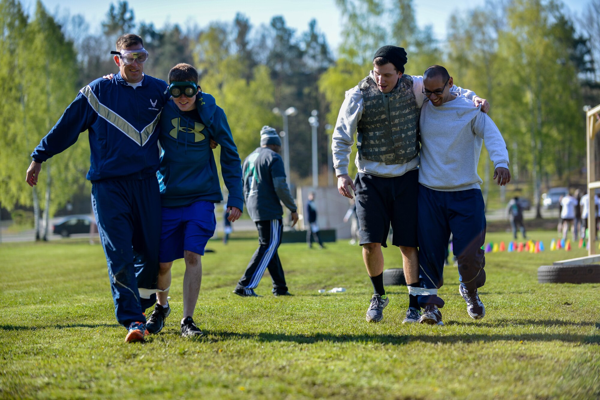 Airmen participating in the Courage, Leadership, Education, Advocate and Respect course, run a three-legged race April, 29, 2016, at Vogelweh Military Complex, Germany. During the obstacle course, Airmen and Soldiers from the Kaiserslautern Military Community had the chance to wear “drunk goggles” to simulate the feeling of functioning under the influence of alcohol. (U.S. Air Force photo/Senior Airman Nicole Keim)