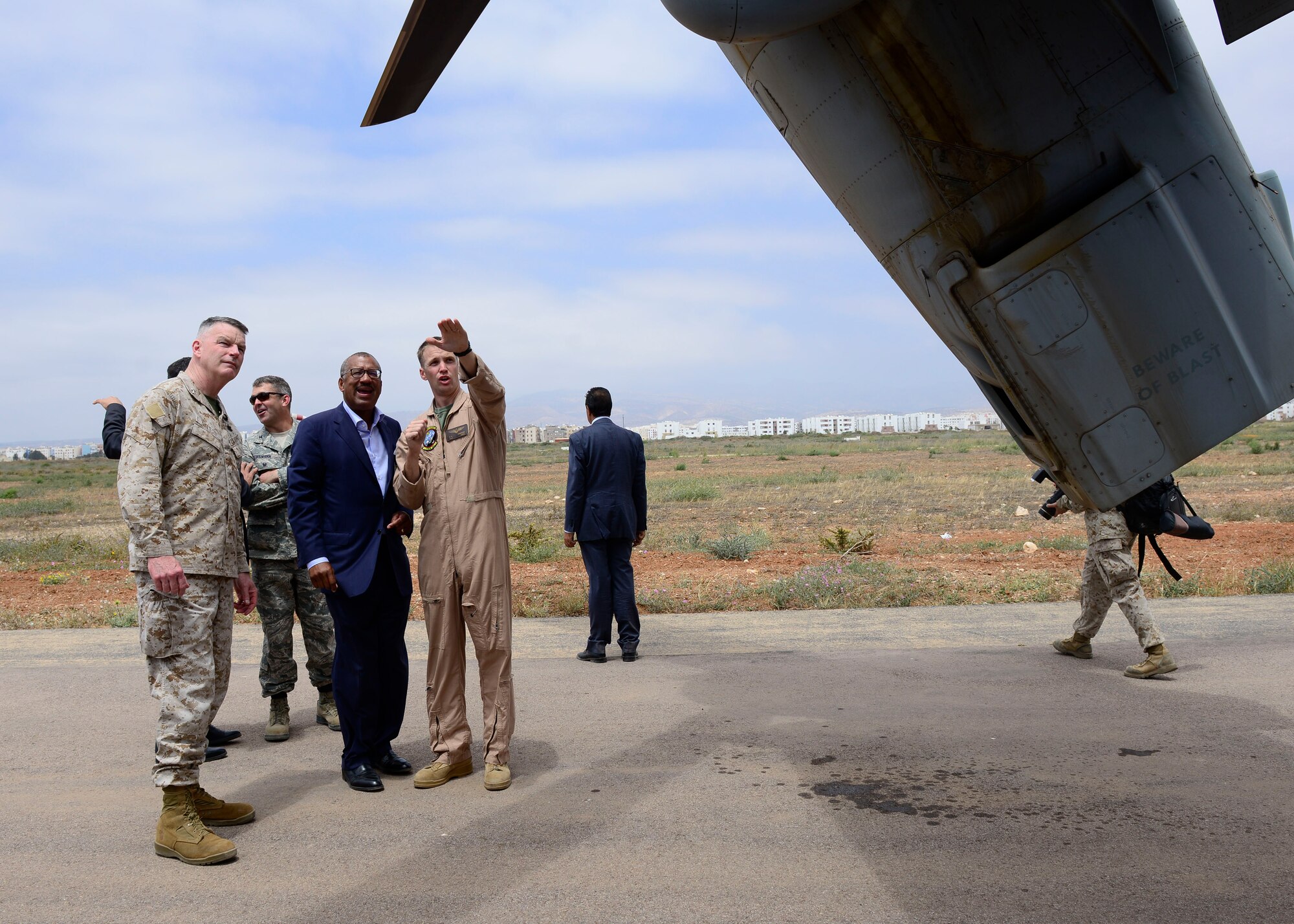 A U.S. Marine Corps MV-22 Osprey pilot explains features of the aircraft to Ambassador Dwight Bush, U.S. Ambassador to Morocco, and Maj. Gen. Niel E. Nelson, U.S. Marine Corps Forces Europe and Africa commander, during AFRICAN LION 16 at Tifnit, Kingdom of Morocco, April 26, 2016. The U.S. Marine Forces Europe-Africa and Kingdom of Morocco-led joint, combined exercise brought together 11 different countries to participate in a Combined Joint Task Force command post exercise and a peace support operations field training exercise to improve interoperability between countries. (U.S. Air Force photo by Senior Airman Krystal Ardrey/Released)