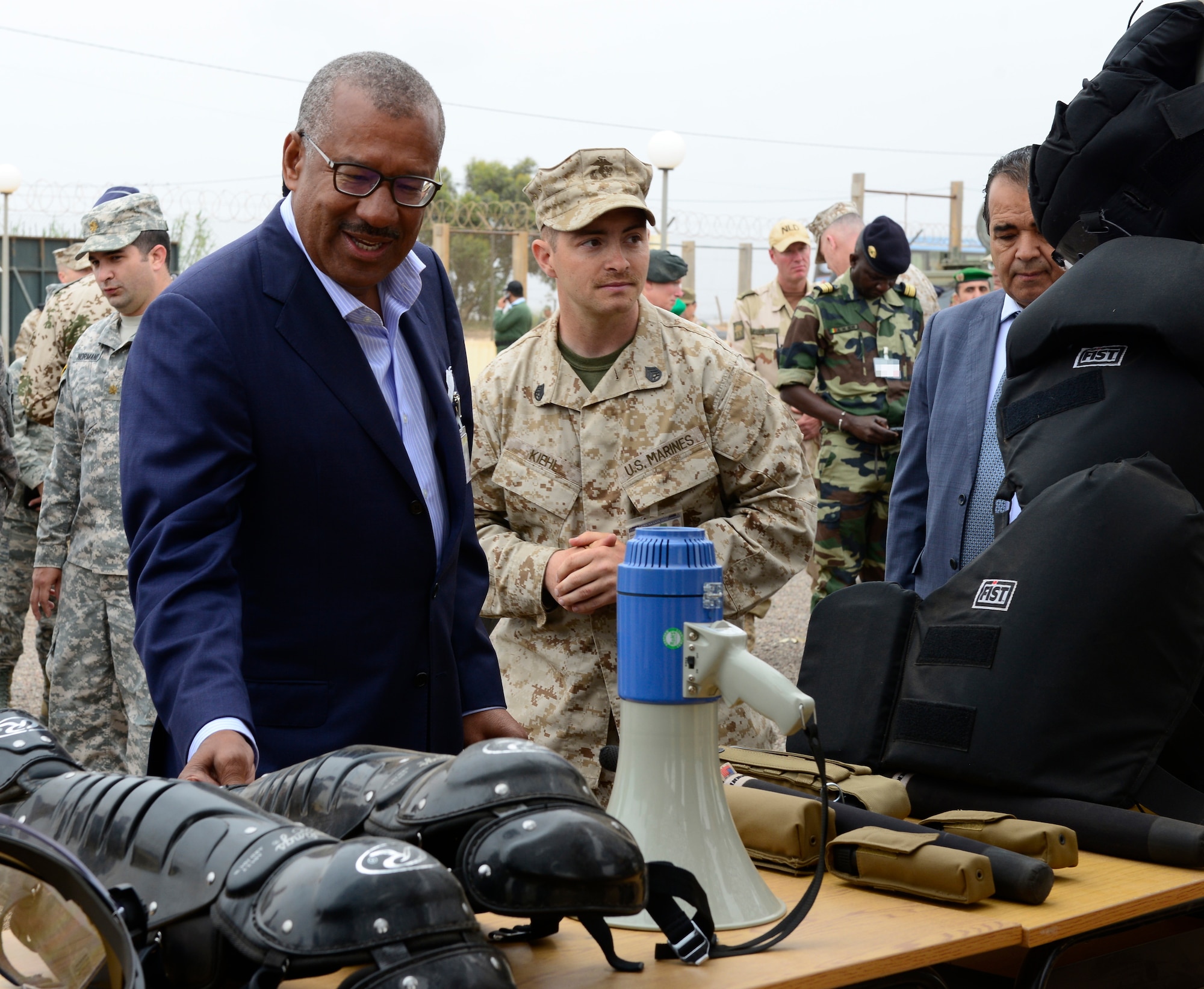 Ambassador Dwight Bush, U.S. Ambassador to Morocco, examines equipment used by different nations during peace support operations as part of AFRICAN LION 16 at Tifnit, Kingdom of Morocco, April 26, 2016. The U.S. Marine Forces Europe-Africa and Kingdom of Morocco-led combined, joint exercise brought together 11 different countries to participate in a Combined Joint Task Force command post exercise and a peace support operations field training exercise to improve interoperability between countries. (U.S. Air Force photo illustration by Senior Airman Krystal Ardrey/Released)