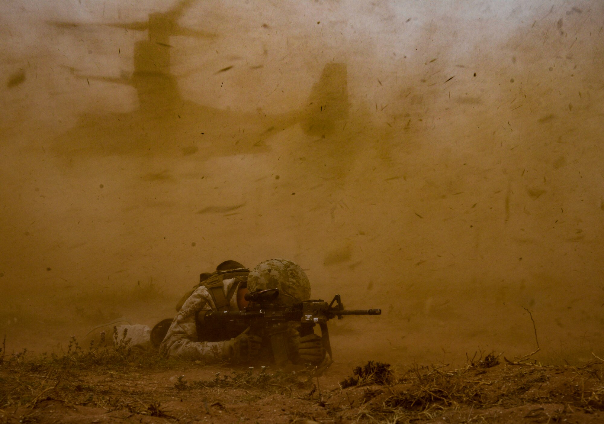 A U.S. Marine Corps Marine provides cover while an MV-22 Osprey departs during a demonstration as part of AFRICAN LION 16 at Tifnit, Kingdom of Morocco, April 26, 2016. 400 U.S. service members joined with over 350 personnel from 10 other countries to create a foundation for future partnerships and provide training to all nations on command post activities and peace support operations. (U.S. Air Force photo by Senior Airman Krystal Ardrey/Released)