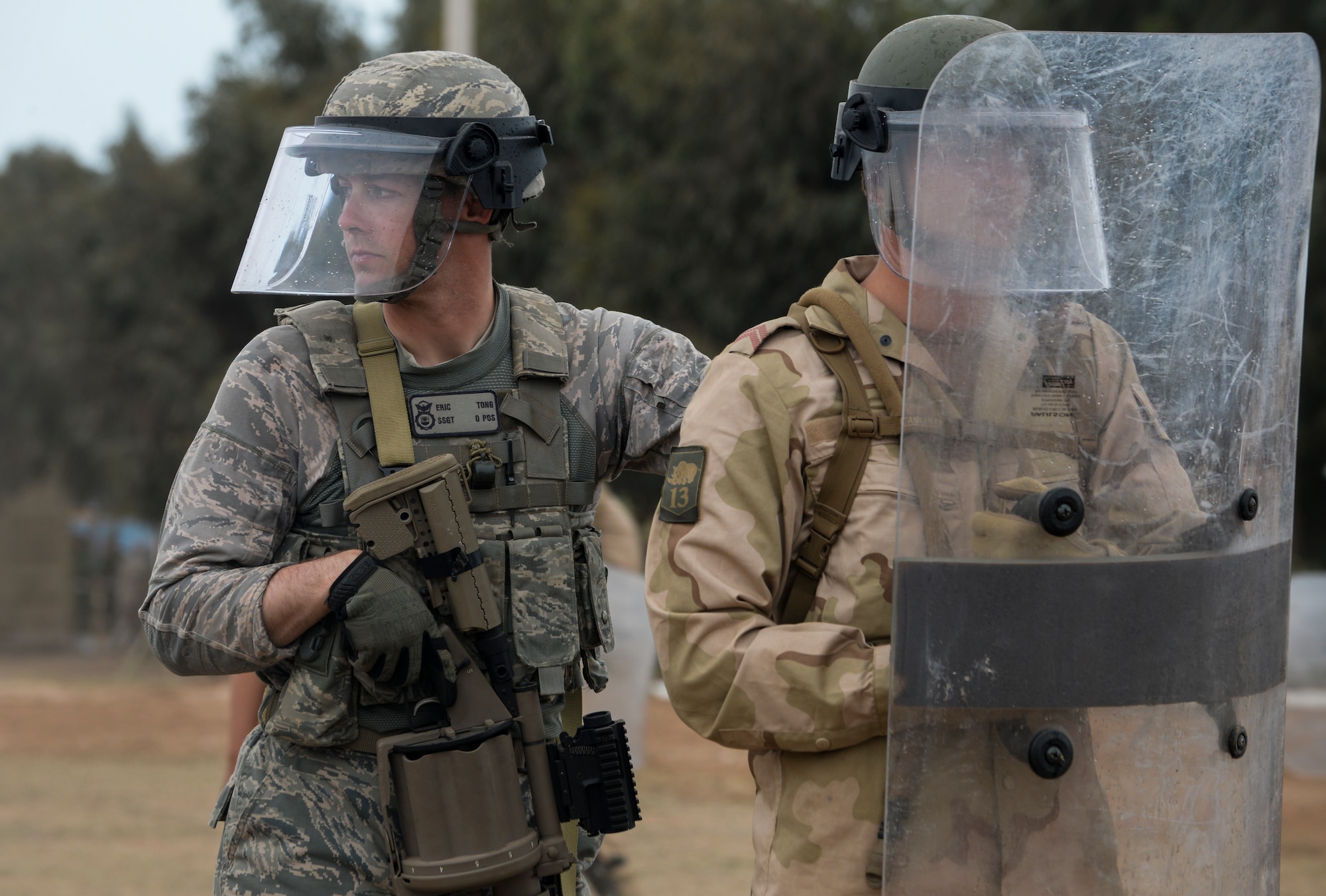 U.S. Air Force Staff Sgt. Eric Tong, 349th Security Forces Squadron fire team leader, and a Royal Netherlands army soldier participate in a peace support operations demonstration during AFRICAN LION 16 at Tifnit, Kingdom of Morocco, April 26, 2016. The exercise provided familiarization with various military techniques from 11 different countries and provided an opportunity to become more familiar with allied nations’ tactics to ease synchronization in the future. (U.S. Air Force photo by Senior Airman Krystal Ardrey/Released)