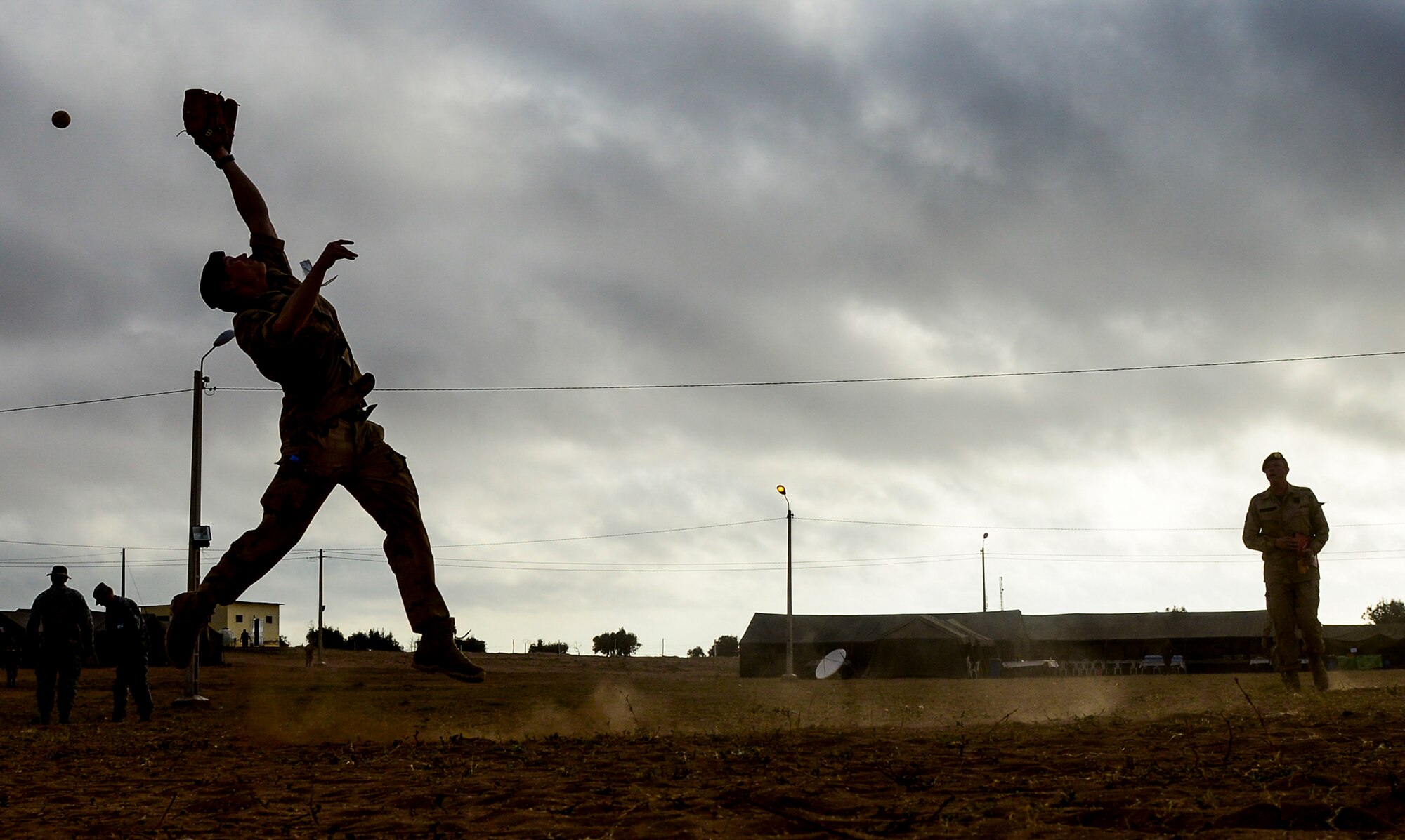A Royal Netherlands Army soldier attempts to catch a baseball while playing catch with other Royal Netherlands soldiers and U.S. Marines after a day of training during AFRICAN LION 16 at Tifnit, Kingdom of Morocco, April 23, 2016. The exercise provided an opportunity to become familiar with the procedures of allied forces as well as including down time in the evening for military members from 11 different nations to get to know one another. (U.S. Air Force photo by Senior Airman Krystal Ardrey/Released)