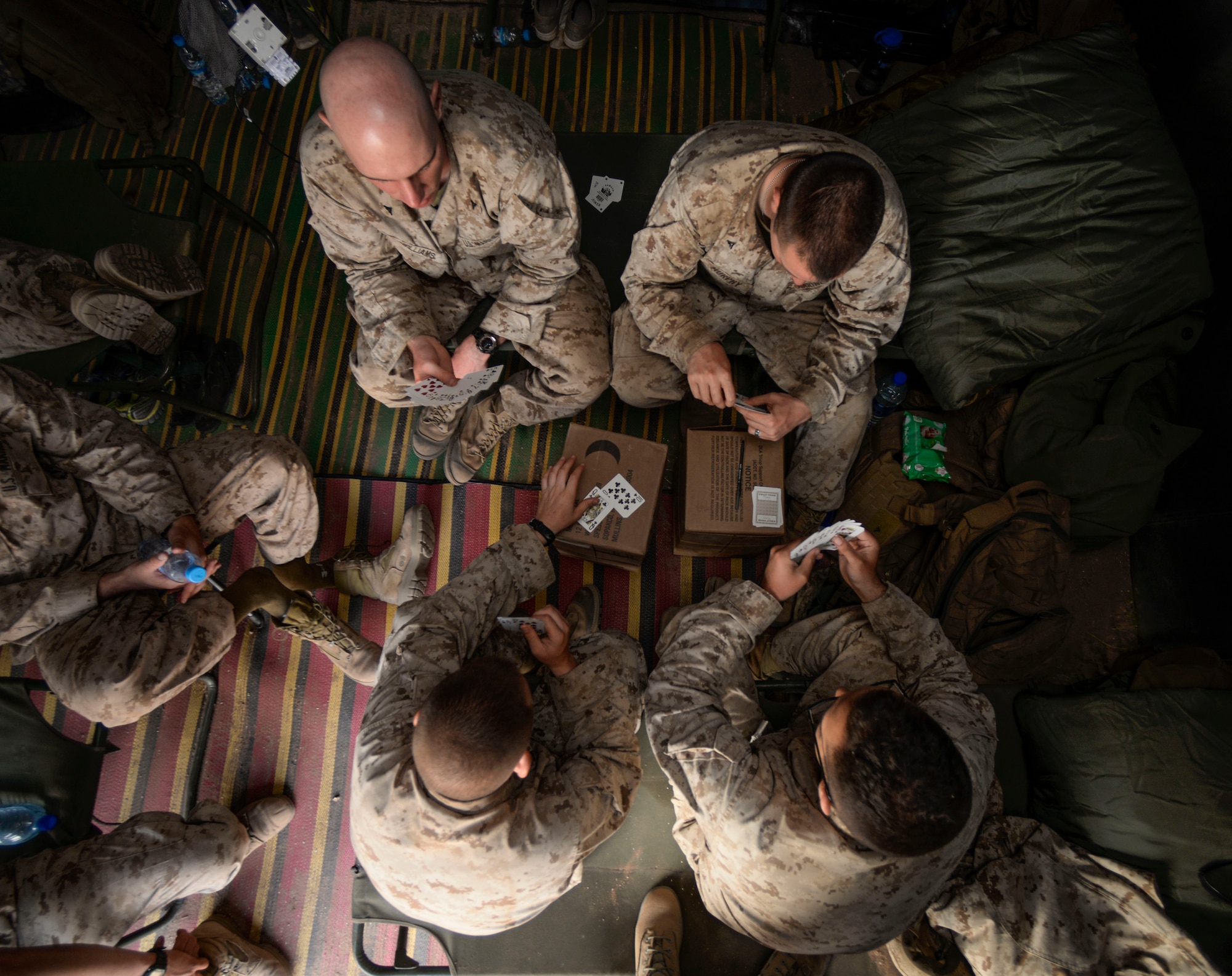 U.S. Marines from the 4th Law Enforcement Battalion play cards after a day of training during AFRICAN LION 16 at Tifnit, Kingdom of Morocco, April 23, 2016. The U.S. Marine Forces Europe-Africa and Kingdom of Morocco-led joint, exercise provided familiarization with various military techniques from 11 different countries and provided an opportunity to become more familiar with allied nations’ tactics to ease synchronization of effort. (U.S. Air Force photo by Senior Airman Krystal Ardrey/Released)
