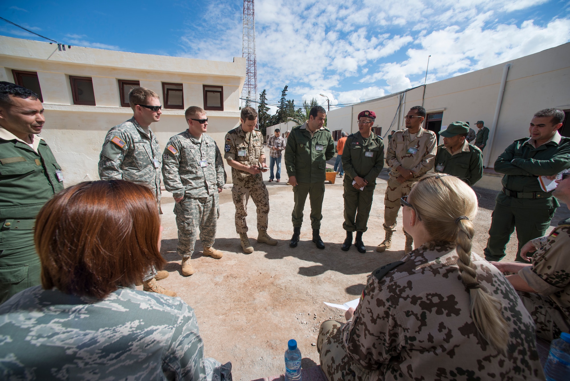 Participants of AFRICAN LION 16 speak together in Agadir, Morocco, April 19, 2016. The annual U.S. Marine Corps Forces Europe and Africa and Kingdom of Morocco-led joint, combined, exercise brought together 11 different countries to participate in a Combined Joint Task Force command post exercise and a peace support operations field training to improved interoperability between countries. (U.S. Air Force photo by Senior Airman Krystal Ardrey/Released)