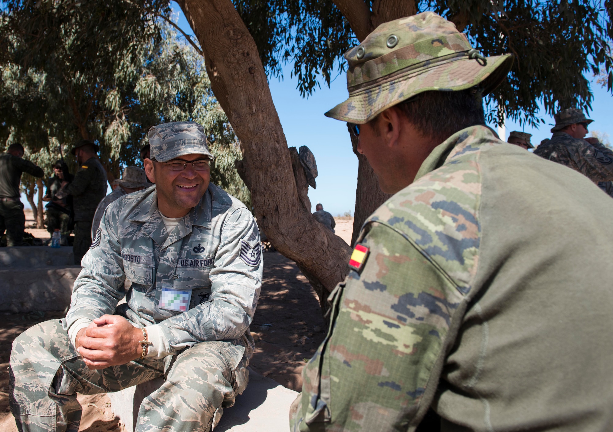 U.S. Air Force Tech. Sgt. Richard Agosto, 920th Security Forces Squadron security forces member, speaks with a Spanish Legion soldier during AFRICAN LION 16 at Tifnit, Kingdom of Morocco, April 22, 2016. The U.S. Marine Forces Europe-Africa and Kingdom of Morocco-led joint, combined exercise brought together 11 different countries to participate in a Combined Joint Task Force command post exercise and a peace support operations field training to improve interoperability between countries. (U.S. Air Force photo by Senior Airman Krystal Ardrey/Released)
