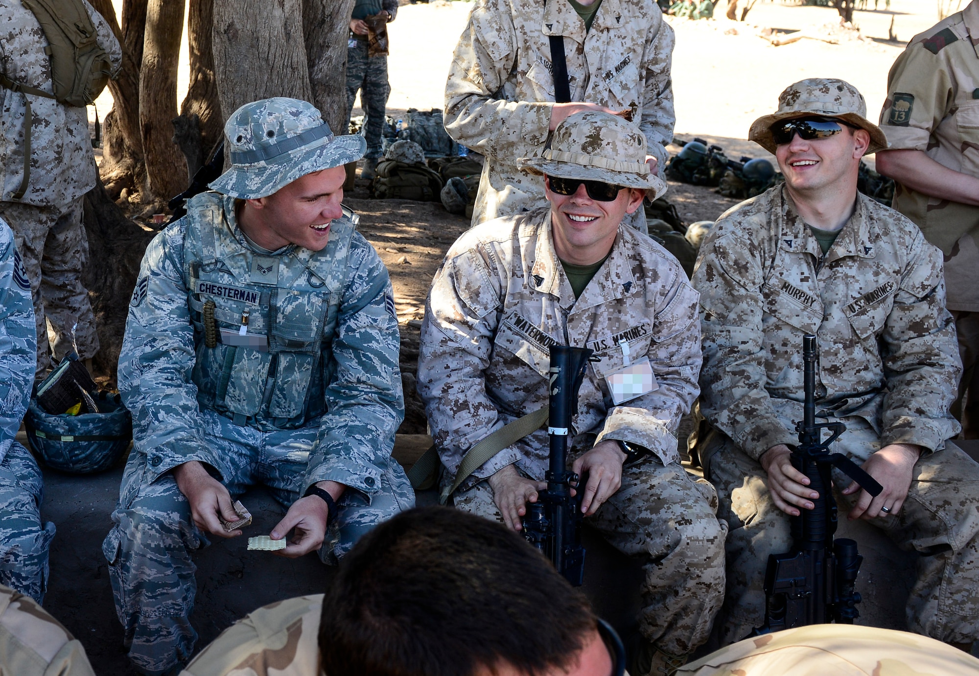 U.S. Air Force Airmen and U.S. Marines laugh together while eating lunch during AFRICAN LION 16 at Tifnit, Kingdom of Morocco, April 22, 2016. The Airmen are Air Force Reservist. The majority of the Air Force contingent are Air Force Reservists or Air Guardsmen. Approximately 400 U.S. service members joined with over 350 personnel from 10 other countries to create a foundation for future partnerships and provide training to all nations on command post activities and peace support operations. (U.S. Air Force photo by Senior Airman Krystal Ardrey/Released)