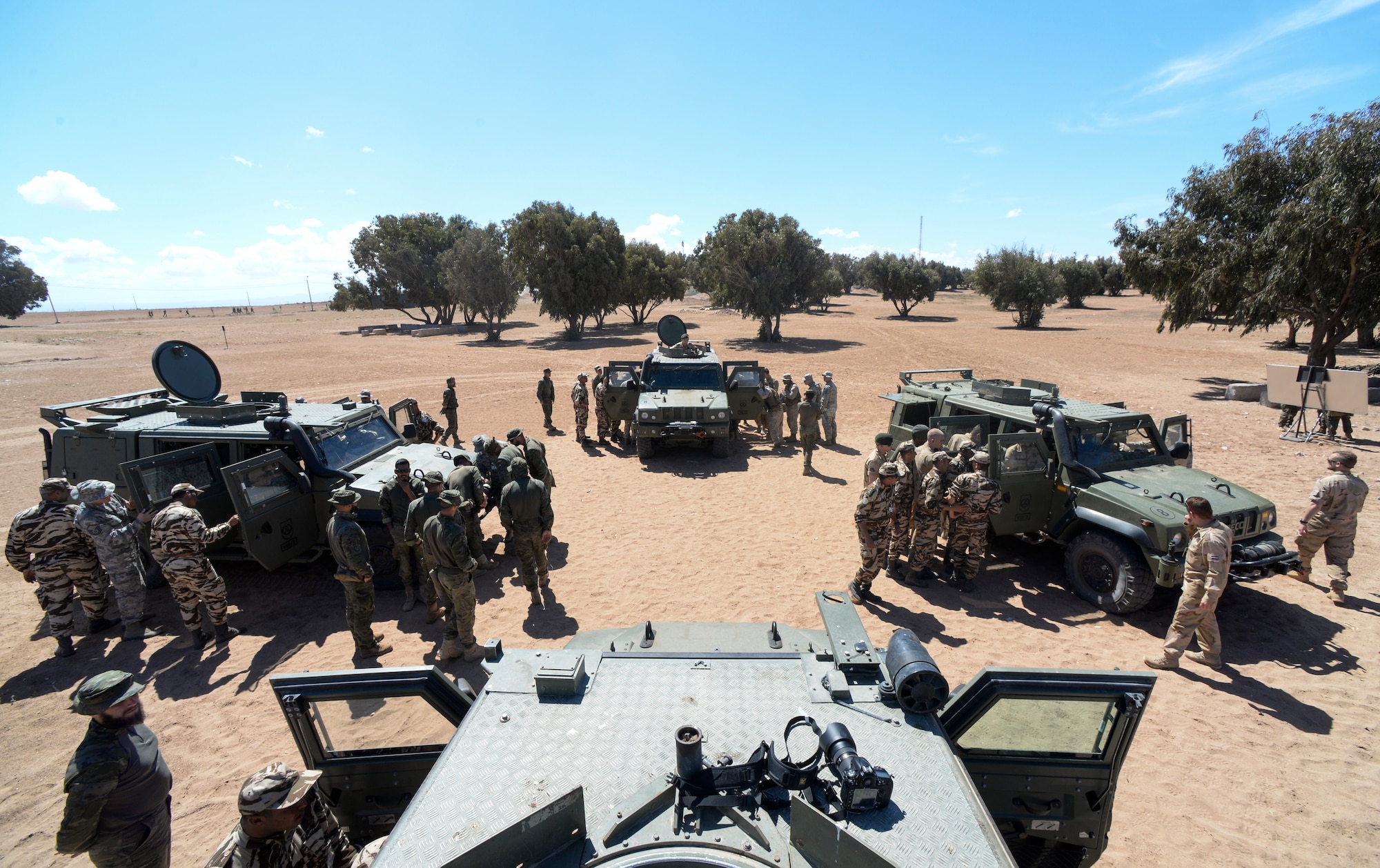Participants of AFRICAN LION 16 examine Humvees from different countries at Tifnit, Morocco, April 20, 2016. The training began with vehicle familiarization and concluded with an exercise in convoy operations. (U.S. Air Force photo by Senior Airman Krystal Ardrey/Released)