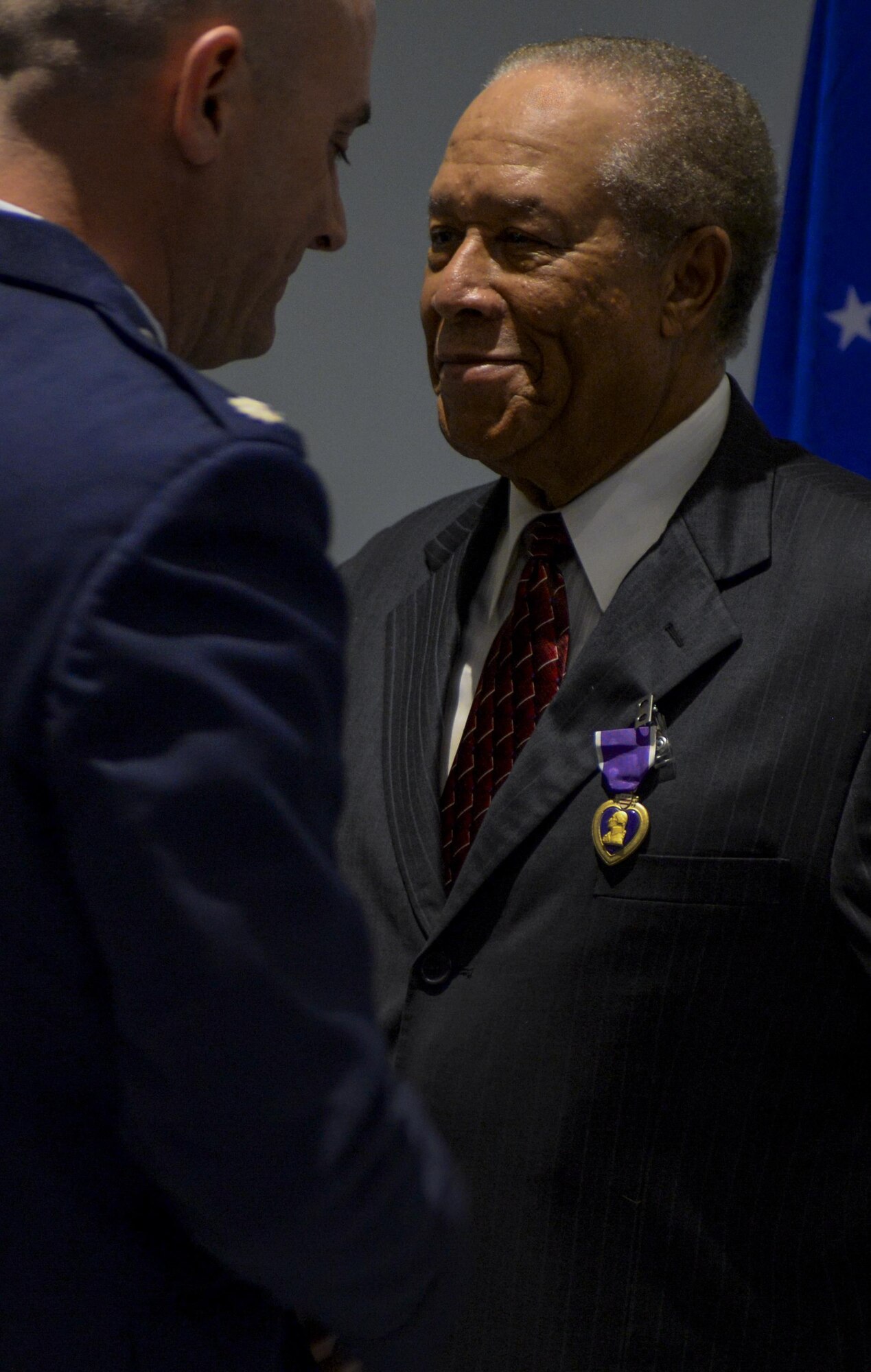 Retired Airman 1st Class Julius Farrar was awarded the Purple Heart by Lt. Col. Kyle Kloeckner at Nellis Air Force Base, Nev., April 28, 2016. Farrar served in the mountains keeping a transmitter working 24 hours a day, seven days a week during the Korean War. (U.S. Air Force photo by Airman 1st Class Kevin Tanenbaum)