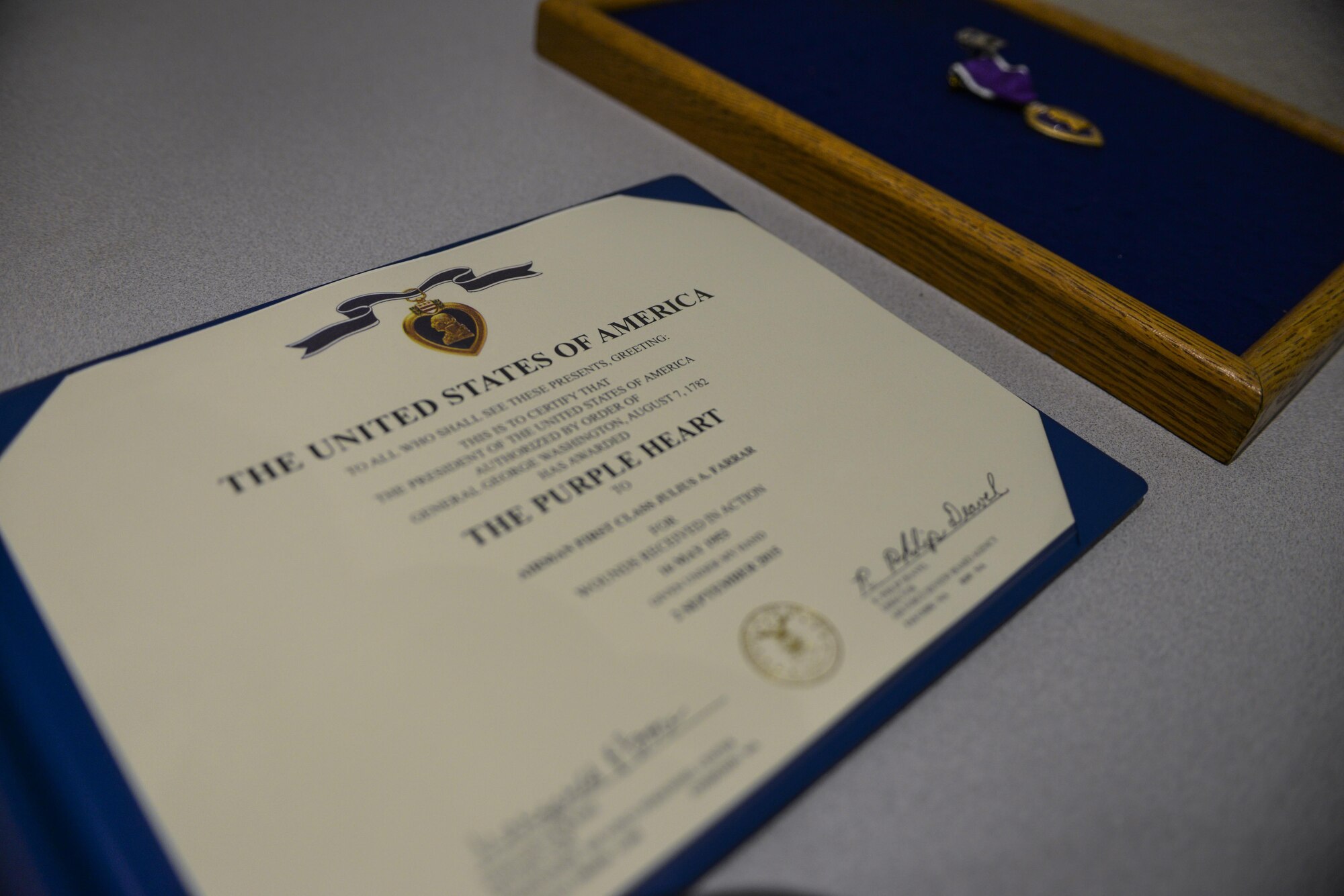 The Purple Heart was presented to retired Airman 1st Class Julius Farrar at Nellis Air Force Base, Nev., April 28, 2016. The Purple Heart is one of the most recognized and respected medals awarded to members of the United States armed forces. (U.S. Air Force photo by Airman 1st Class Kevin Tanenbaum)
