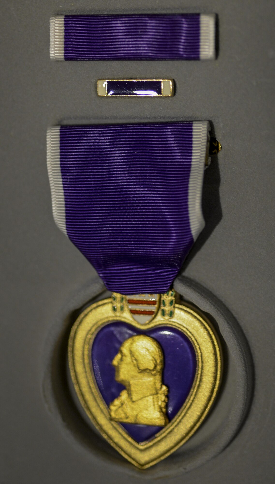 The Purple Heart was awarded to retired Airman 1st Class Julius Farrar at Nellis Air Force Base, Nev., April 28, 2016. On August 7, 1782 during the revolutionary war, General George Washington issued an order establishing the honorary badge of distinction: The Purple Heart. (U.S. Air Force photo by Airman 1st Class Kevin Tanenbaum)