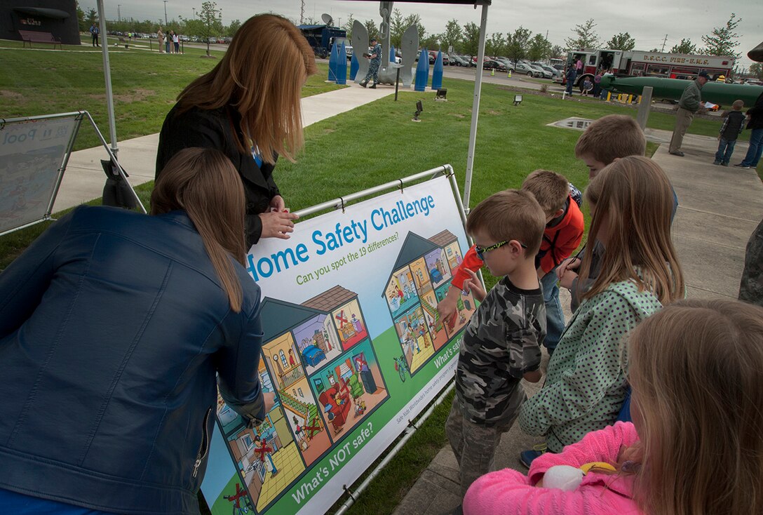 Installation associates give a safety presentation to children as they work their way through displays and activities featured in the installation’s Mission Park.