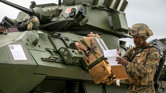 Lance Cpl. Anton Pyant, a landing support specialist with 2nd Transportation Support Battalion, Combat Logistics Regiment 2, organizes, manages and tracks all equipment and personnel that the Landing Craft Air Cushion drops off at Marine Corps Base Camp Lejeune, North Carolina, April 29, 2016.  Parachute riggers with 2nd TSB developed their skills by cross-training with landing support specialists.
