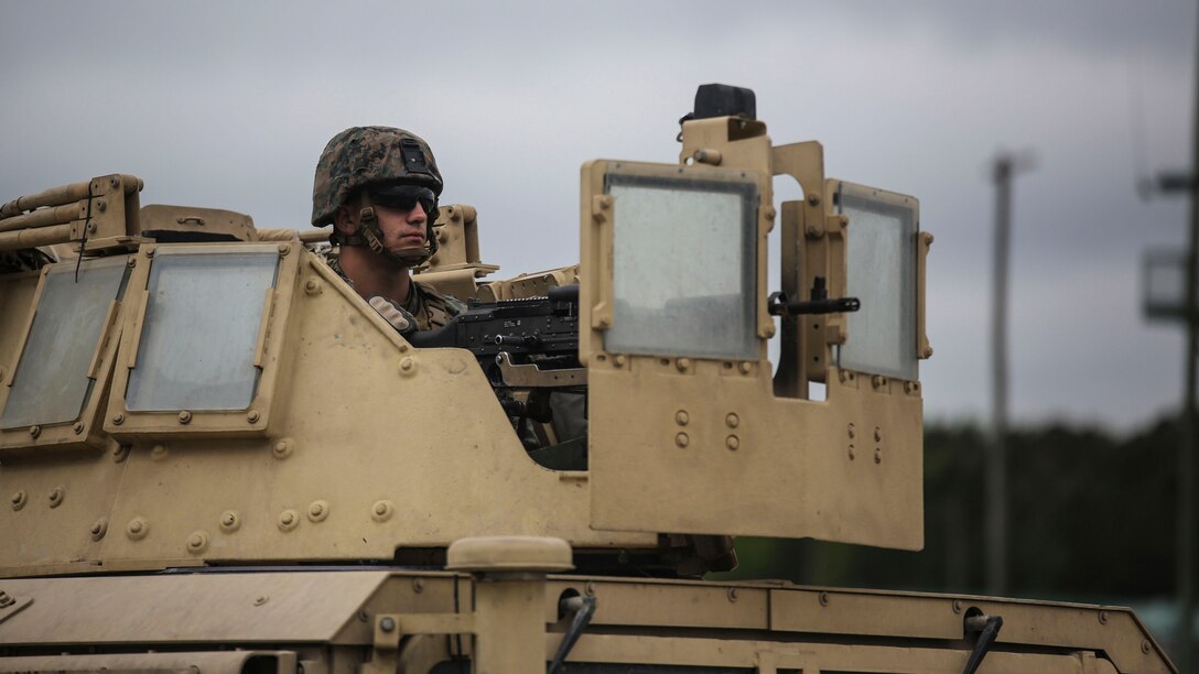 Lance Cpl. Casey Hall, a motor transport vehicle operator with Headquarters and Service Company, 2nd Tank Battalion, searches for targets down range behind an M240B medium machine gun during a field exercise at Marine Corps Base Camp Lejeune, North Carolina, April 29, 2016. Marines began the exercise by firing the M240B medium machine gun and .50-caliber machine gun from tripods before mounting them on a moving Humvee.