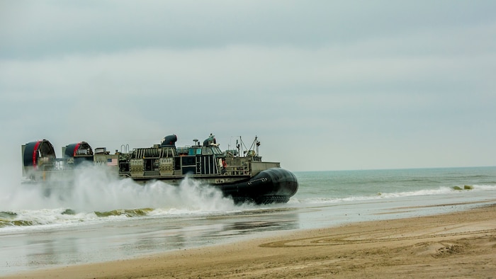 A Landing Craft Air Cushion arrives on the beach, bringing back equipment, vehicles, and Marines from the 26th Marine Expeditionary Unit at Marine Corps Base Camp Lejeune, North Carolina, April 29, 2016. Parachute riggers with 2nd TSB developed their skills by cross-training with landing support specialists. 