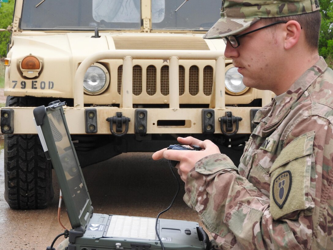A U.S. Army EOD technician guides a robot via remote control during Raven’s Challenge X at Fort Wolters, Texas, April 20, 2016. Participants used the robot to search for incendiary explosive devices embedded within a wall. (U.S. Air Force Photo/Steve Warns/Released)