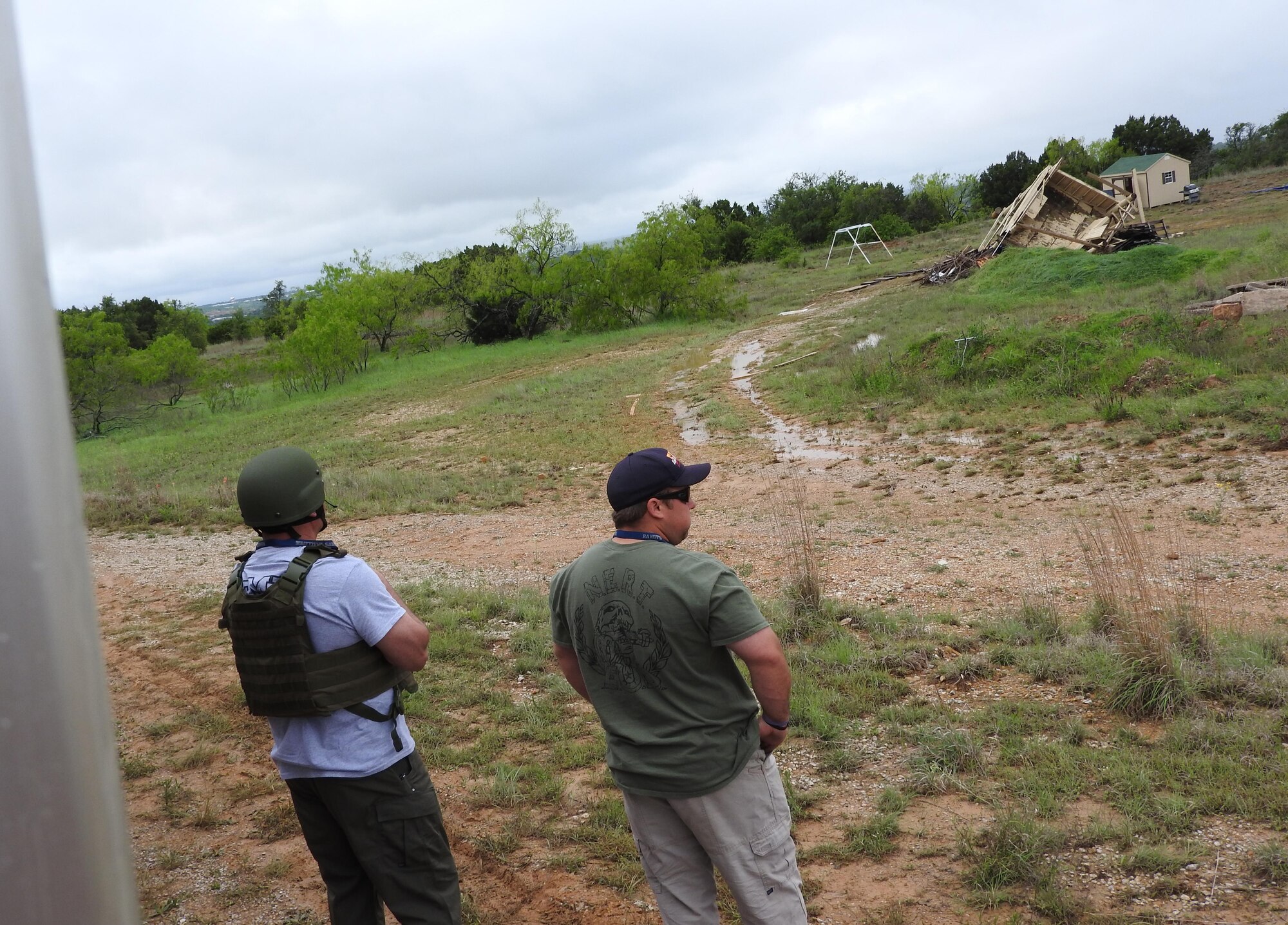Raven’s Challenge participants observe a booby-trapped cabin during an exercise at Fort Wolters, Texas, April 20, 2016. The cabin was armed with incendiary explosive devices and EOD technicians were tasked with finding and disarming them. (U.S. Air Force Photo/Steve Warns/Released)