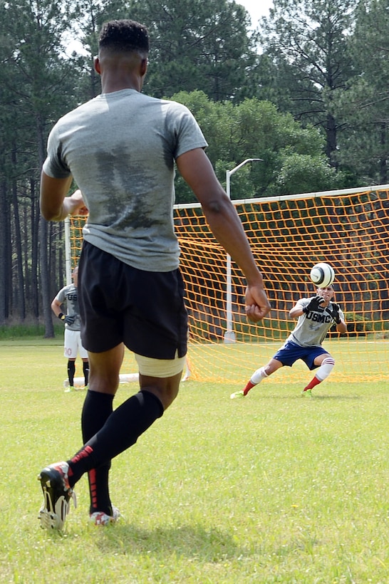 Sgt. Miguel Cebrero, goalie, All-Marine Men’s Soccer Team, blocks a shot from Sgt. Jean St. Germain, during the All-Marine Men’s Soccer Team tryouts aboard Marine Corps Logistics Base Albany, Ga., April 25. Cebrero is a supply chief with 3rd Low Altitude Air Defense, Camp Pendleton, Calif. Germain is a supply administration clerk with 2nd Radio Battalion, Camp Lejeune, N.C.