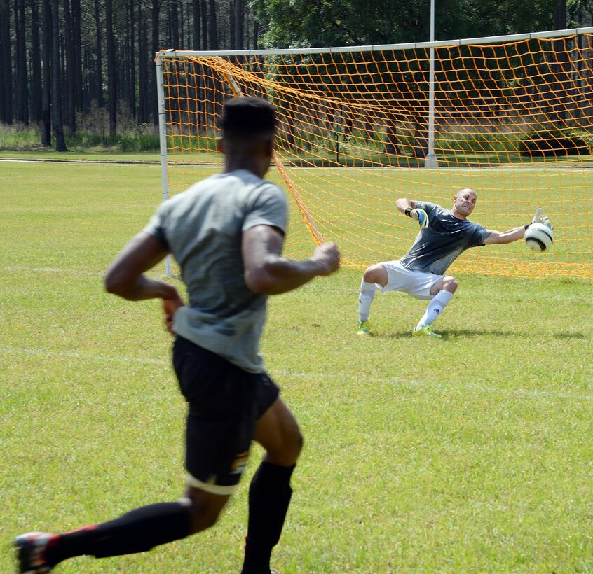 Staff Sgt. Rocky Fredin, goalie and team captain, All-Marine Men’s Soccer Team, blocks a shot from Sgt. Jean St. Germain, a team member during the All-Marine Men’s Soccer Team tryouts aboard Marine Corps Logistics Base Albany, Ga., April 26. Fredin, a native of Lawrenceville, Ga., has been nicknamed the ‘grand old man’ by his teammates because this is his sixth time being selected for the All-Marine Men’s Soccer Team. Germain is a supply administration clerk with 2nd Radio Battalion, Camp Lejeune, N.C.