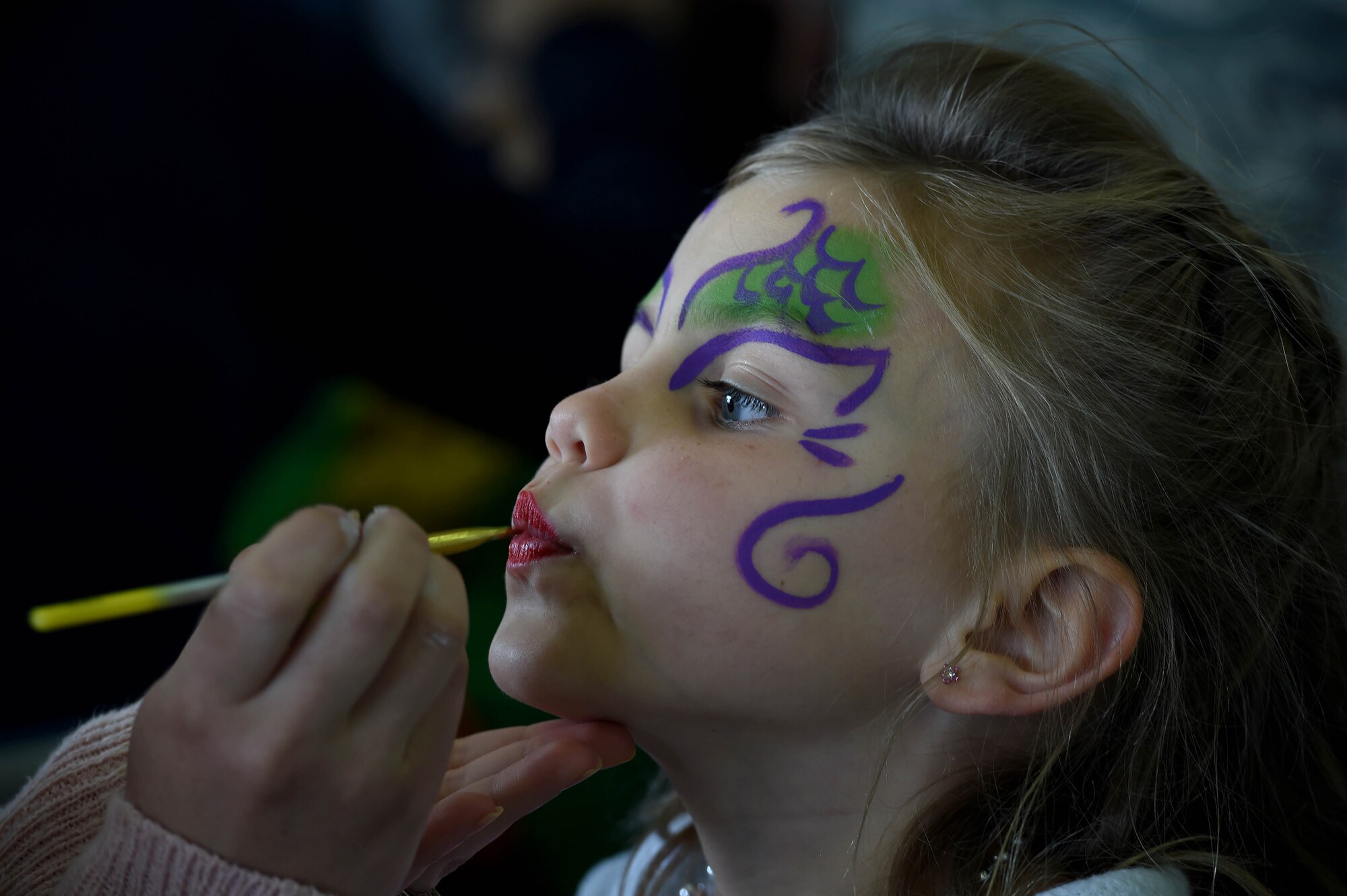 A child of Team Creech gets her face painted during “Take Your Kid to Work Day” event April 28th, Creech Air Force Base, Nevada. The event was hosted by the 432nd Wing to teach children of Team Creech about base mission sets and consisted of fun activities, squadron tours, and demonstrations from the 799th Security Force Squadron and Nellis/Creech Fire Department. (U.S. Air Force photo by Senior Airman Adarius Petty/Released)