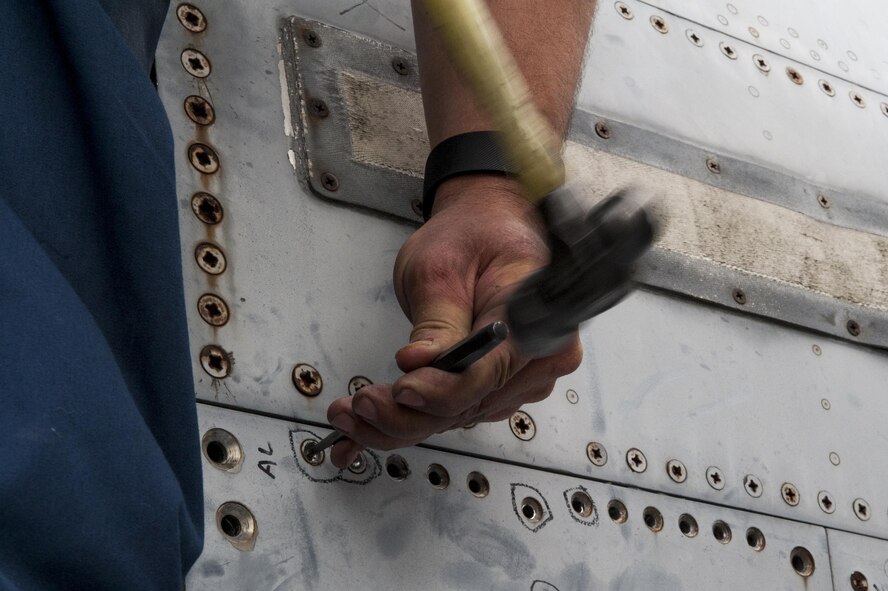 U.S. Air Force Tech. Sgt. Jason Rodocker, 23d Equipment Maintenance Squadron repair and reclamation craftsman, chisels a screw on a side panel of an F-4 Phantom II, April 28, 2016, at Moody Air Force Base, Ga. The F-4 retired from the Air Force and will now sit in the Veteran’s Memorial Park in Excel, Ala. (U.S. Air Force photo by Airman 1st Class Lauren M. Hunter/Released)