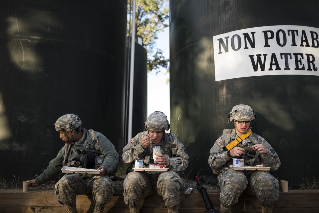 Spc. Roshan Jaspau, Pfc. Maksim Tsaryk and Pfc. Allison Chrisman, all U.S. Army Reserve Soldiers with the 490th Quartermaster Company, of Rochester, New York, eat breakfast at Forward Operating Base Schoonover while training at Fort Hunter-Liggett, California, May 3. Approximately 80 units from across the U.S. Army Reserve, Army National Guard and active Army are participating in the 84th Training Command's second Warrior Exercise this year, WAREX 91-16-02, hosted by the 91st Training Division at Fort Hunter-Liggett, California. (U.S. Army photo by Master Sgt. Michel Sauret)