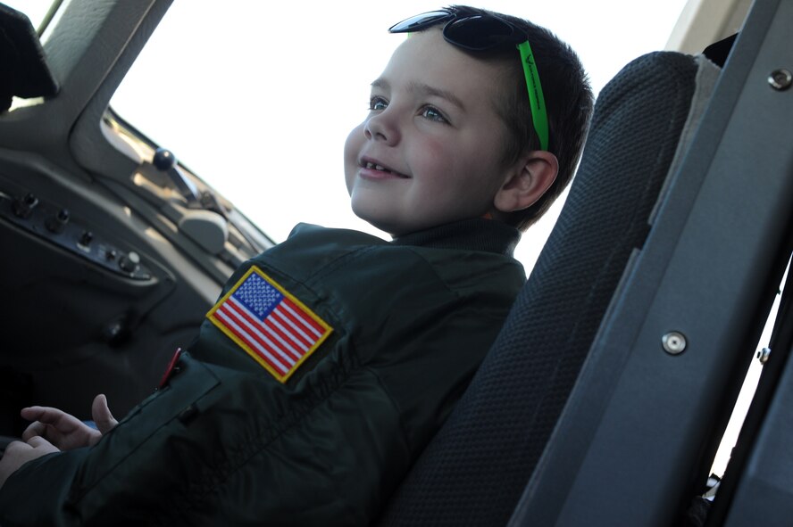 A 7-year-old cancer patient enjoys the view from the flightdeck of a static KC-10 Extender, April 17 during his visit to Joint Base McGuire-Dix-Lakehurst, New Jersey. The youth spent the day with members of the 514th Air Mobility Wing, along with the college-run, nonprofit organization, Love Your Melon, that jointly organized his special tour.