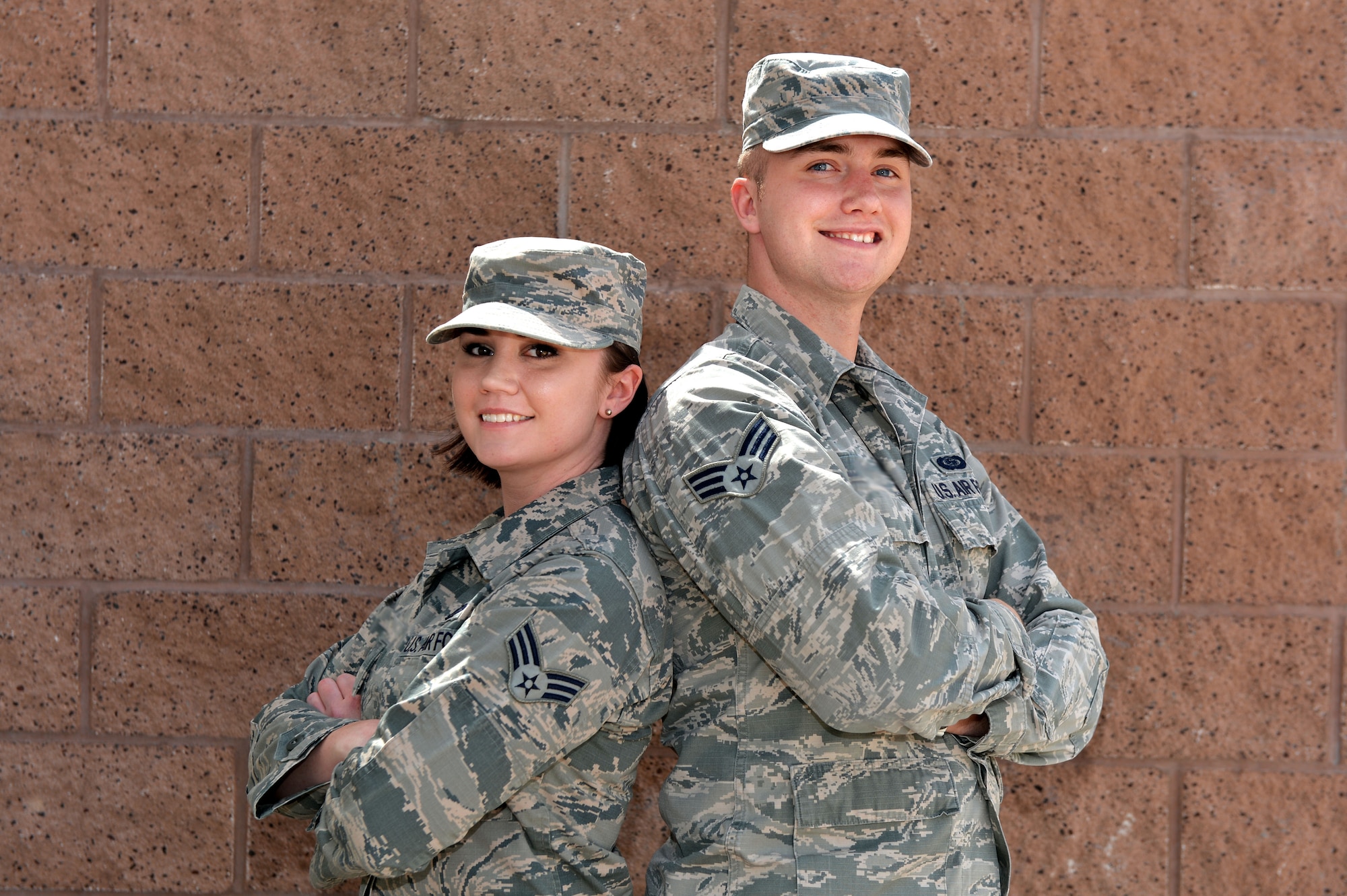 Senior Airman Megan and Senior Airman Dylon, Intelligence Formalized Training Unit (IFTU) instructors with the 432nd Operations Support Squadron, pose for a picture April 22nd, 2016, at Creech Air Force Base, Nevada. All intelligence analysts assigned to Creech must complete the three week course to meet initial qualifications. IFTU instructors teach the basic tasks to lay a solid foundation critical for advancement and completing in-depth tasks. (U.S. Air Force photo by Airman 1st Class Kristan Campbell/Released)