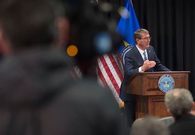 Defense Secretary Ash Carter speaking with reporters at a podium.