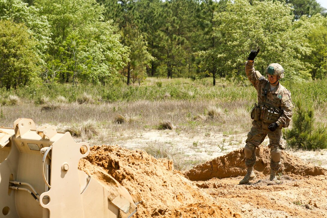 Army Spc. Macqueen Le guides an excavator during an airfield damage repair training exercise at Fort Bragg, N.C., April 27, 2016. Le is a horizontal construction engineer assigned to the 82nd Airborne Division’s 127th Engineer Battalion, 1st Brigade Combat Team. Army photos by Sgt. Juan F. Jimenez.