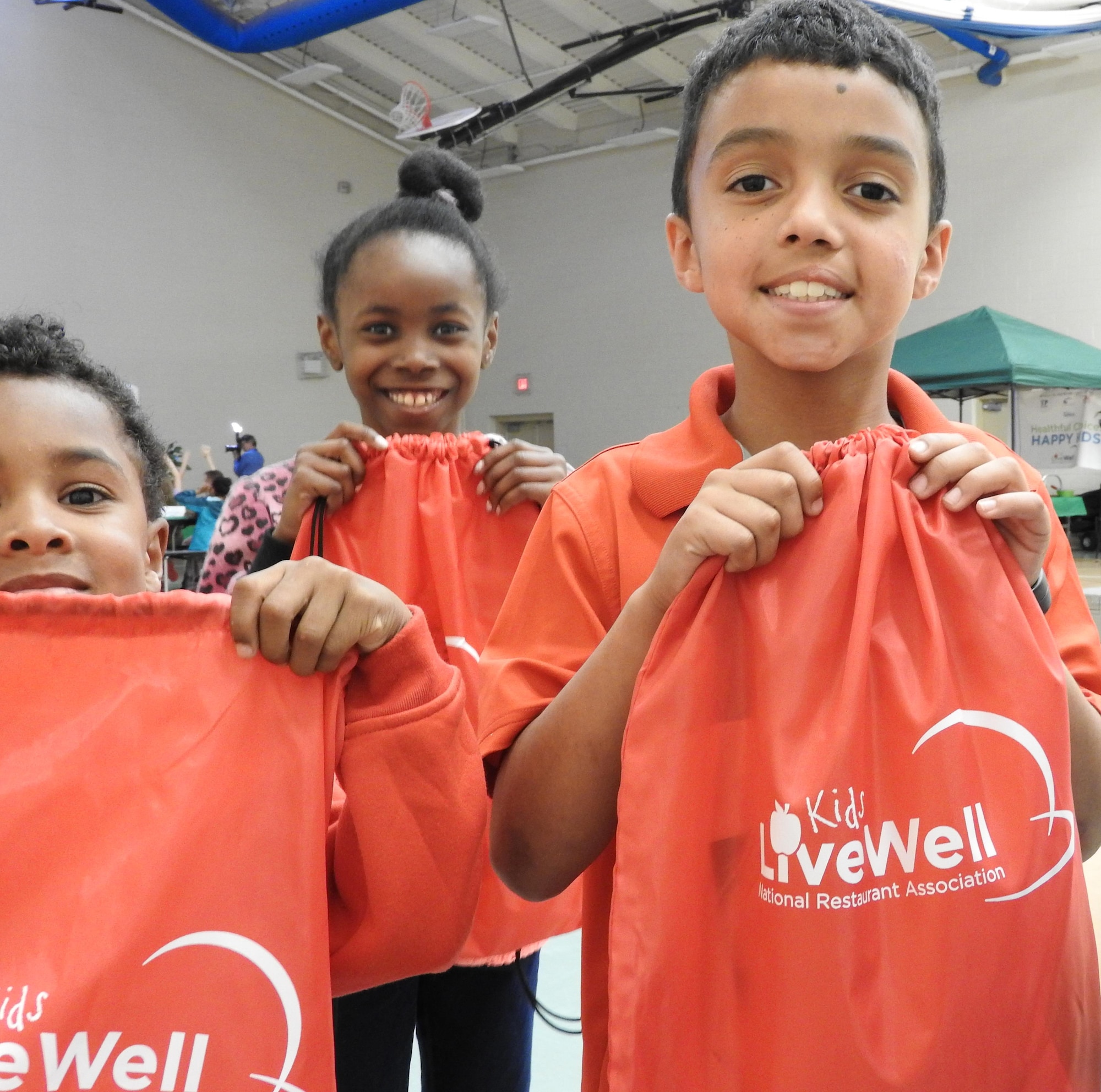 Joseph Clark, 8, holds his Kids LiveWell goodie bag, which was presented to children and teenagers who attended the kick off of Kids LiveWell, a partnership among the Air Force, the National Restaurant Association and Sysco Foods, on April 14 at Joint Base San Antonio-Lackland. (U.S. Air Force photo/Steve Warns/released)