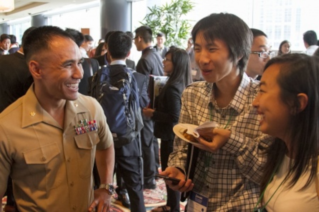 Major Anthony Nguyen, Operations Officer, 9th Communication Battalion, Houston native, shares a story about his Marine Corps experience with two attendees at the Society of Asian Scientists and Engineers (SASE) National Convention and Fair in Houston on Oct. 9, 2015. Partnering with influential organizations like SASE provides the Marine Corps with the ability to build relationships with influential community leaders and transform them into brand ambassadors of the Marine Corps. One of the goals of the partnership is to educate the members of this organization about the opportunities the Marine Corps can provide both inside and outside the Corps.