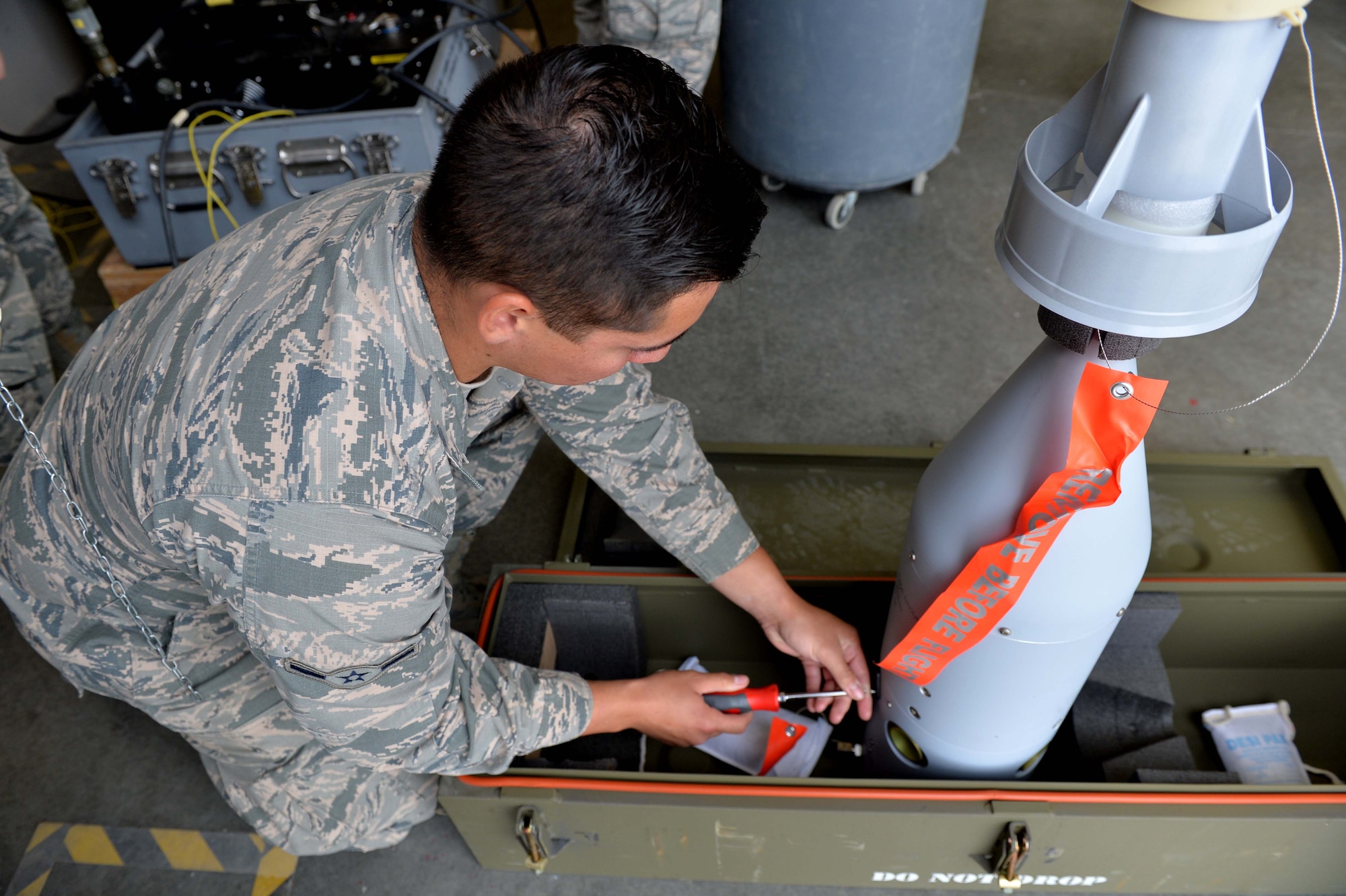 Airman Andrew, 432nd Maintenance Squadron munitions flight crew member, performs maintenance on a computer control group in preparation for a bomb build April 27, 2016, at Creech Air Force Base, Nevada. Col. Case Cunningham, 432nd Wing/432nd Air Expeditionary Wing commander, and Chief Master Sgt. Michael Ditore, 432nd Wg/432nd AEW command chief, assisted in the build as part of Ditore’s shadow an Airman initiative. The program was put into place as a way for leadership to better understand their Airmen’s contributions to the mission and boost unit morale within the wing. (U.S. Air Force photo by Airman 1st Class Kristan Campbell/Released).