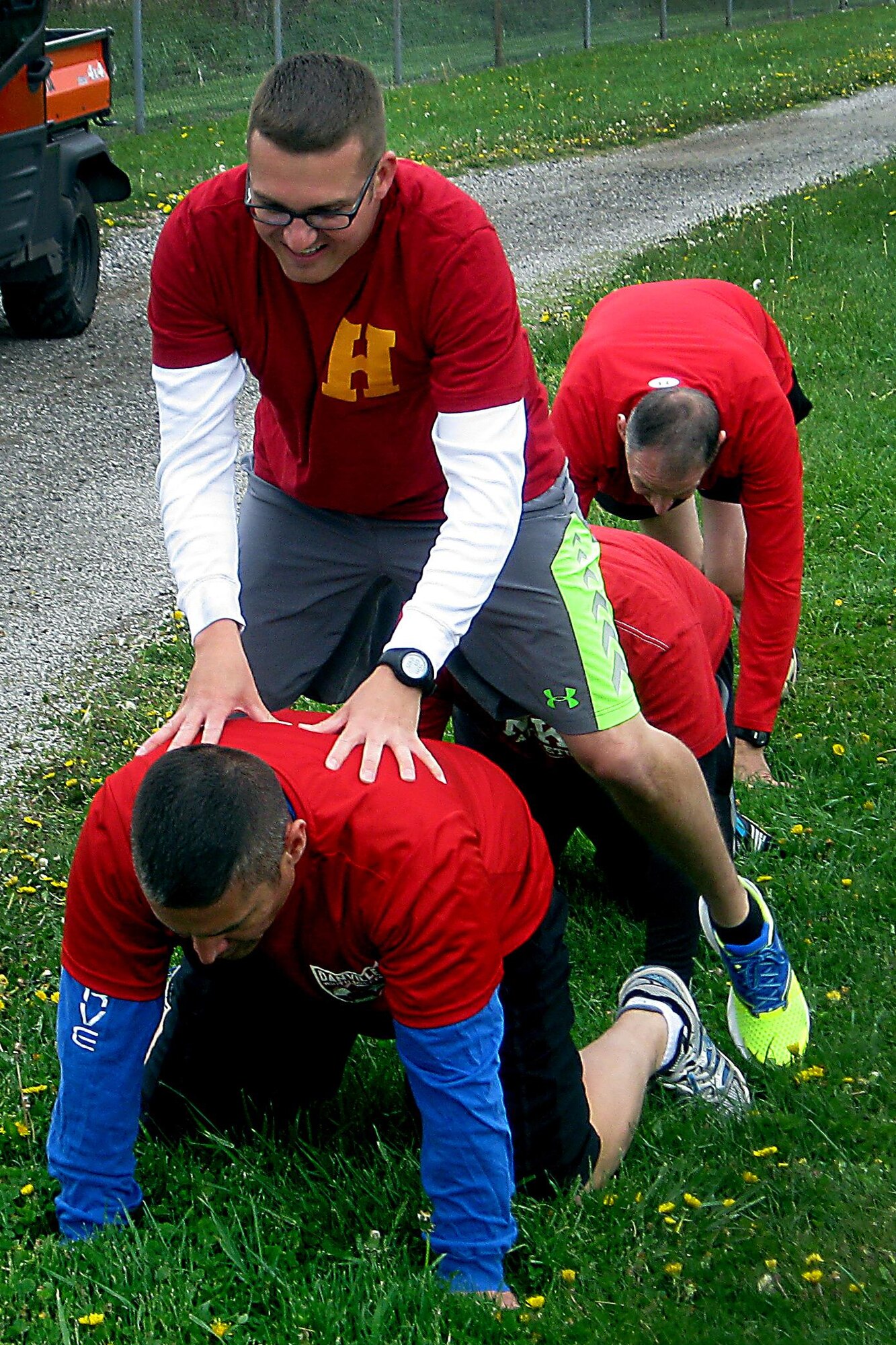 Zach Chapin, 434th Air Refueling Wing, leapfrogs over his teammates during the 2016 Plastic Egg Run April 27, 2016 at Grissom Air Reserve Base, Ind. Playing leapfrog was one of many possible challenges that the teams had to complete during the 5K. (U.S. Air Force photo/Senior Airman Dakota Bergl)