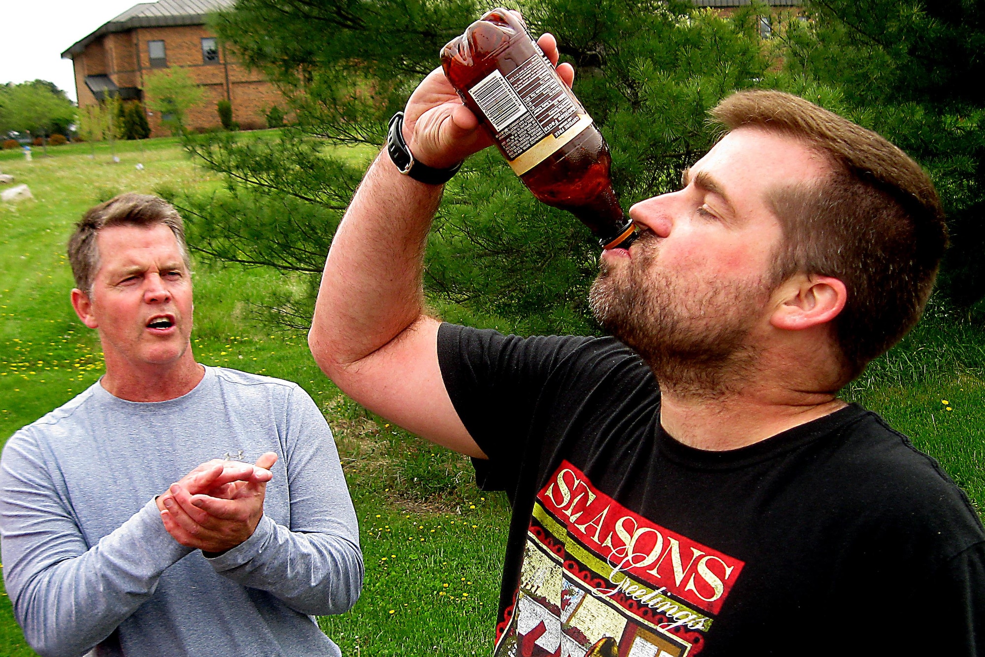 Zachery Holmes, 434th Force Support Squadron, finishes drinking a root beer during the 2016 Plastic Egg Run April 27, 2016 at Grissom Air Reserve Base, Ind. Drinking the entire bottle was the challenge that his team had to complete at one of the stops before continuing the run. (U.S. Air Force photo/Senior Airman Dakota Bergl)