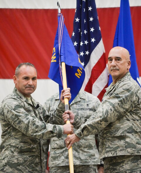 Col. Kurt Gallegos, 944th Fighter Wing commander, hands the medical squadron guidon to Col. Curtiss Cook, 944th Medical Squadron commander, during a change-of-command ceremony April 30 at Luke Air Force Base, Ariz. (U.S. Air Force photo by Staff Sgt. Nestor Cruz)