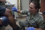 Senior Airman Jessica Drake, 359th Medical Operations Squadron medical technician, spreads iodine on a patient’s knee prior to a procedure at the Joint Base San Antonio (JBSA) - Randolph Medical Clinic, May 2, 2016. Iodine is used to clean a patient’s skin in order to reduce the chance of infection. The 359th MDOS is a part of the 359th Medical Group at JBSA-Randolph. The group averages 8,320 outpatient visits, 38,750 prescriptions, 5,064 lab procedures, and 2,000 radiology films per month. (U.S. Air Force photo by Senior Airman Stormy Archer/Released)